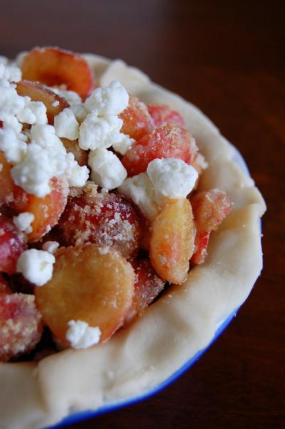 Close up of the cherry and goat cheese filling in a pie pan. 