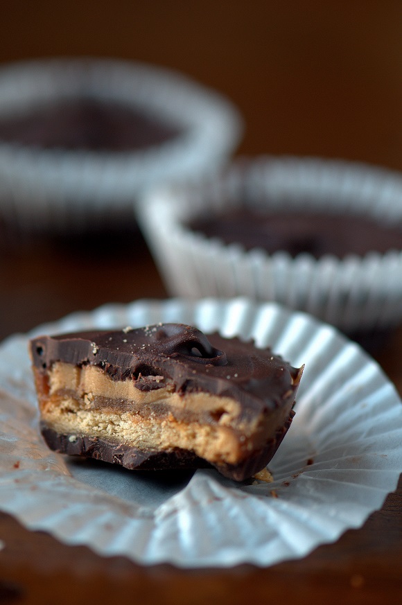 Side view of a cracker toffee with bite out of it. 