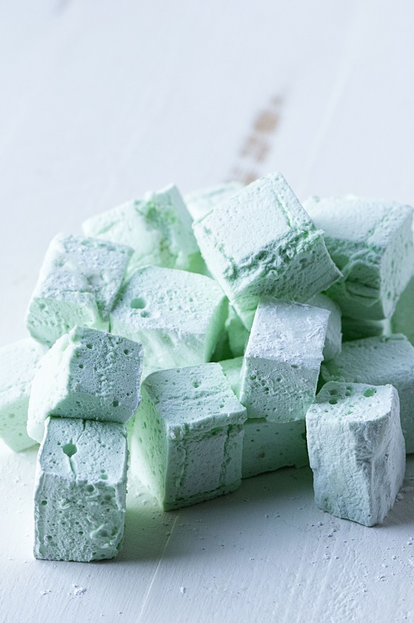 Side view of pile of green marshmallows.