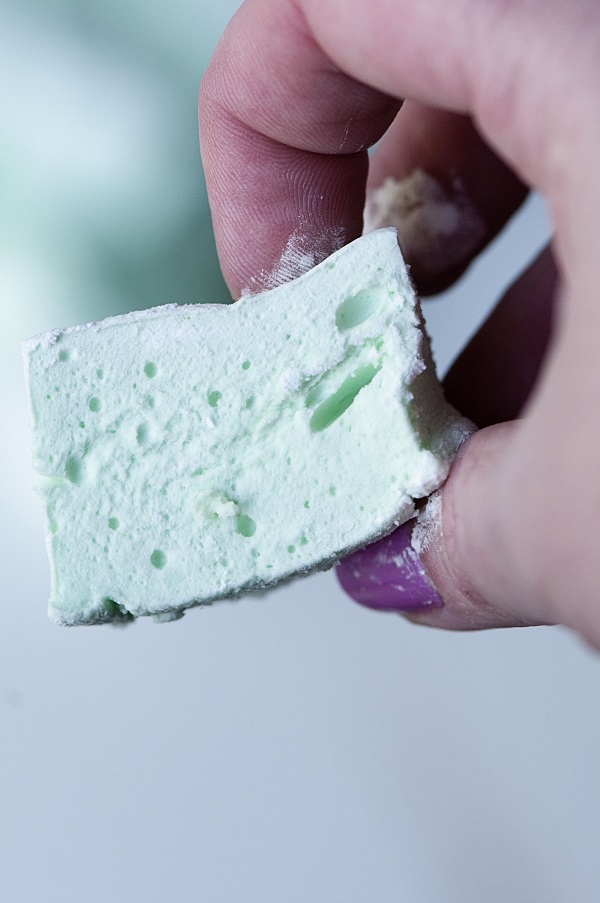 Green mint marshmallow in hand.
