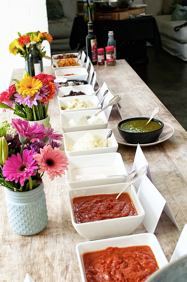 Bowls of various pizza toppings to put on flatbread