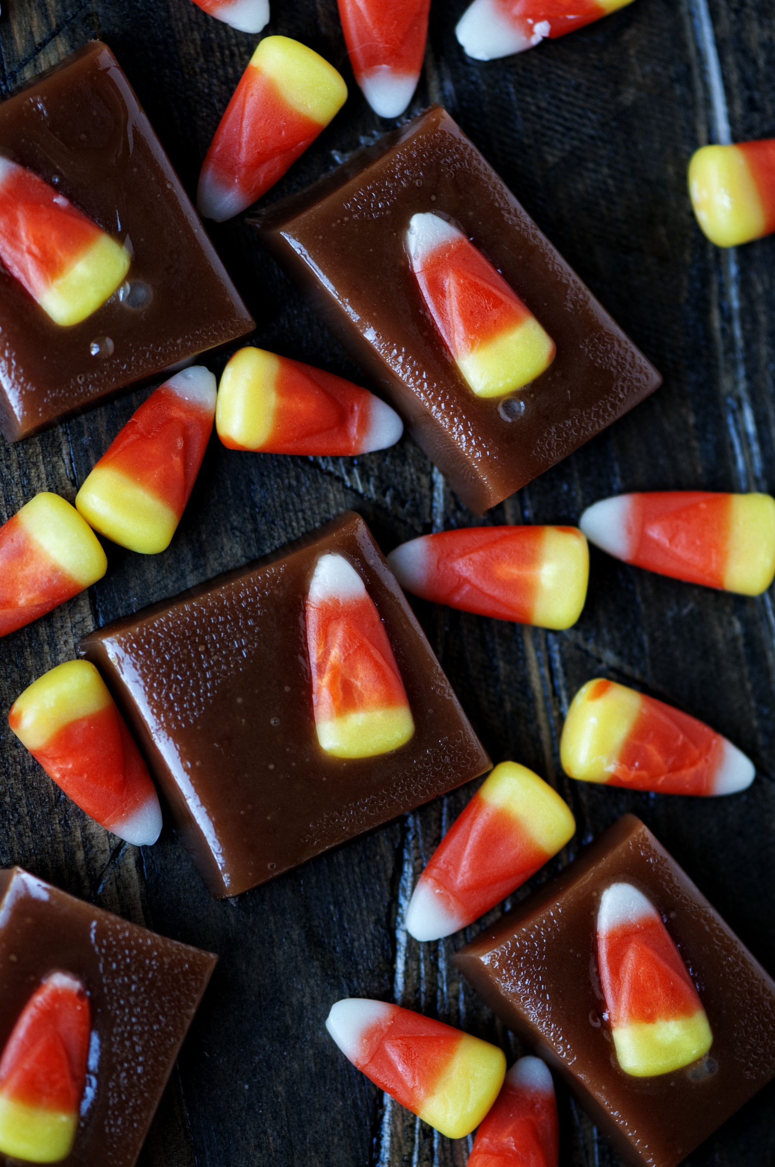 Overhead shot of candy corn caramels scattered around with extra candy corns