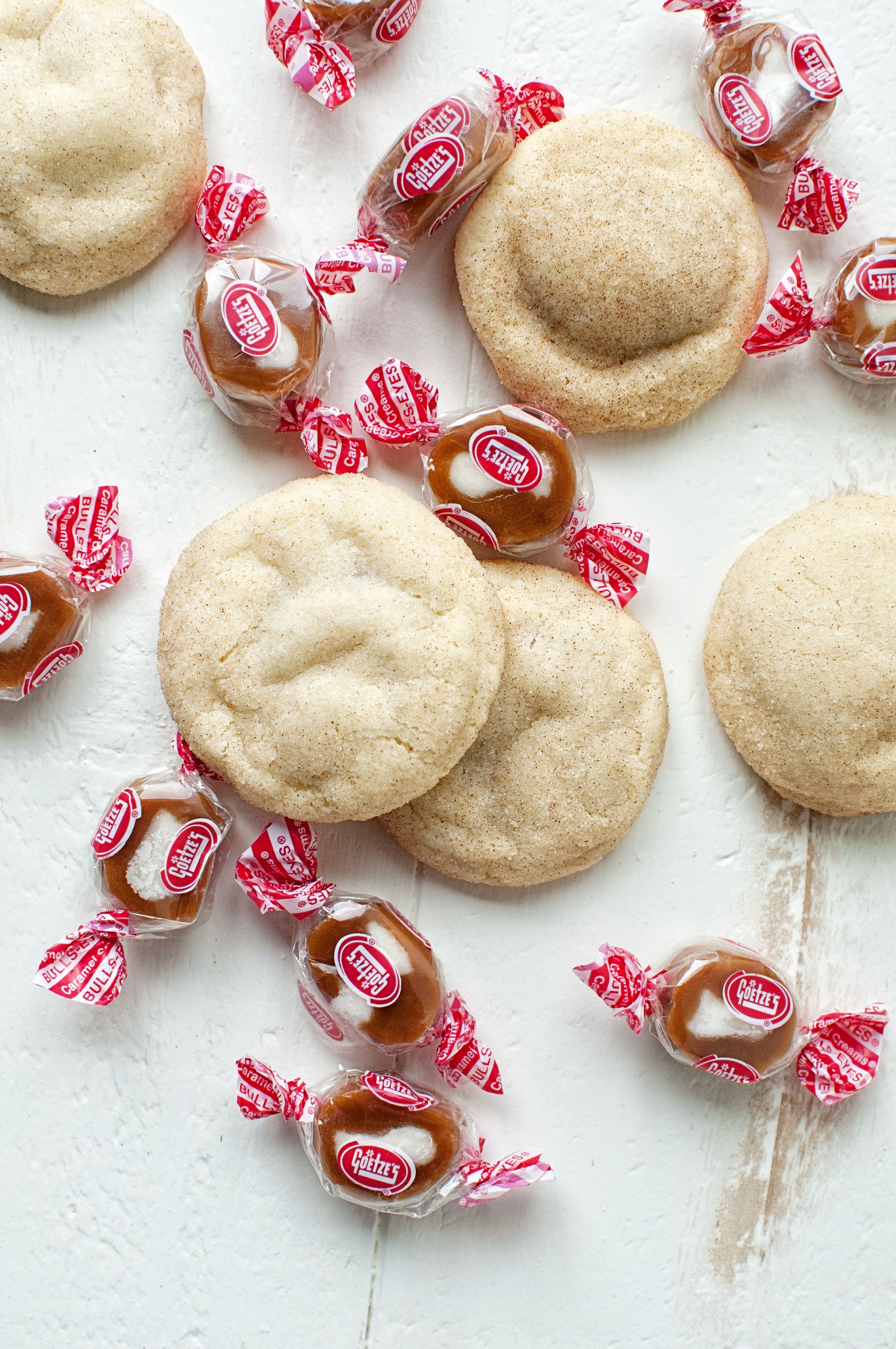 Overhead shot of Caramel Cream Filled Snickerdoodles with candies scattered. 