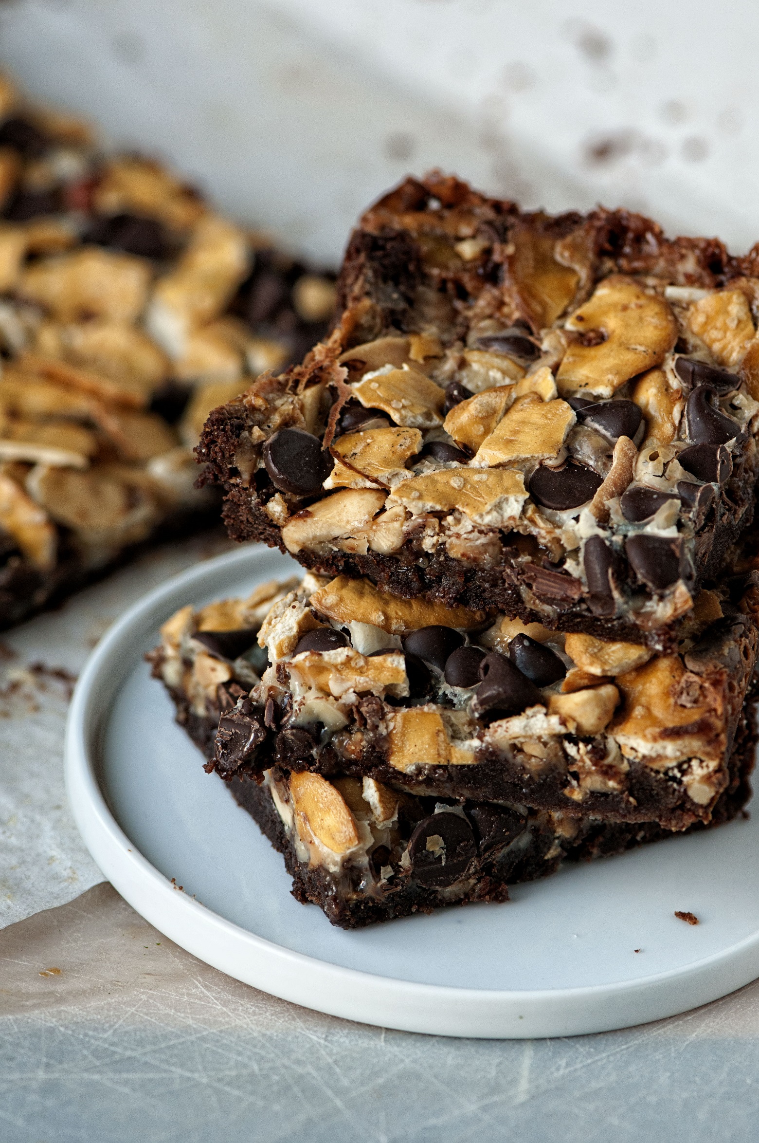 Three Cowboy 7 Layer Cookie Bars stacked up on a plate. 