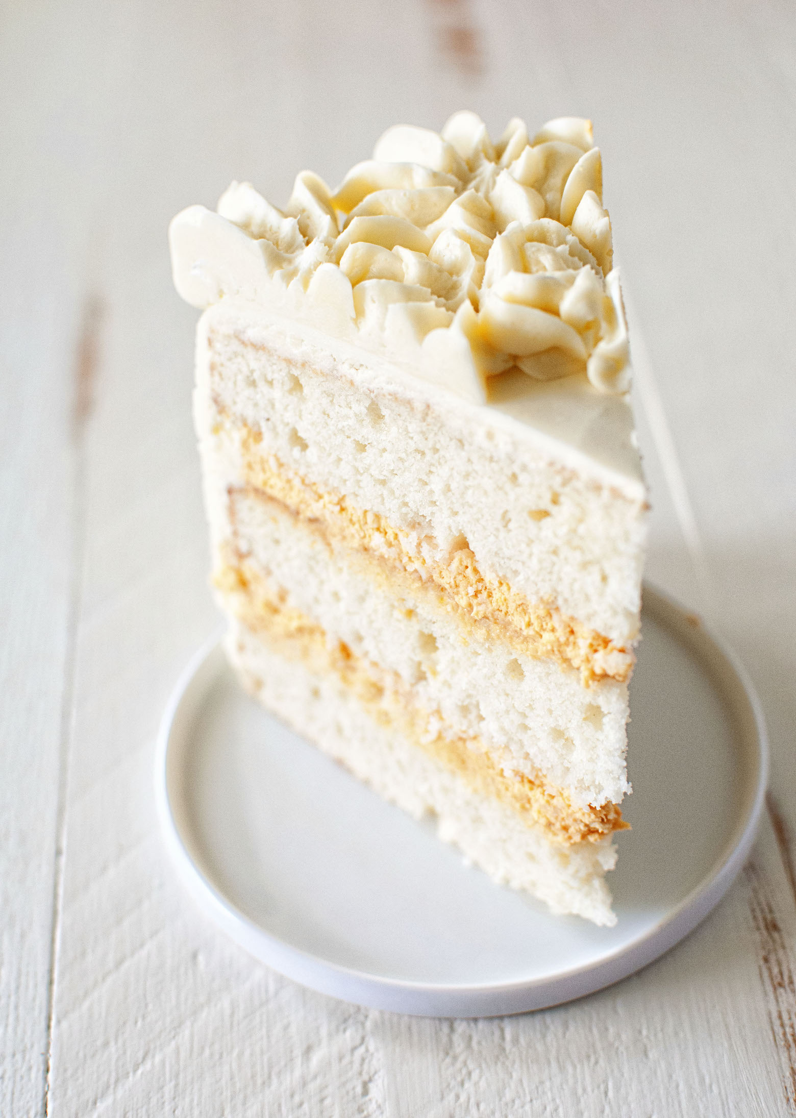 Single slice of Buttermilk Bourbon Pumpkin Cheesecake Layer Cake 