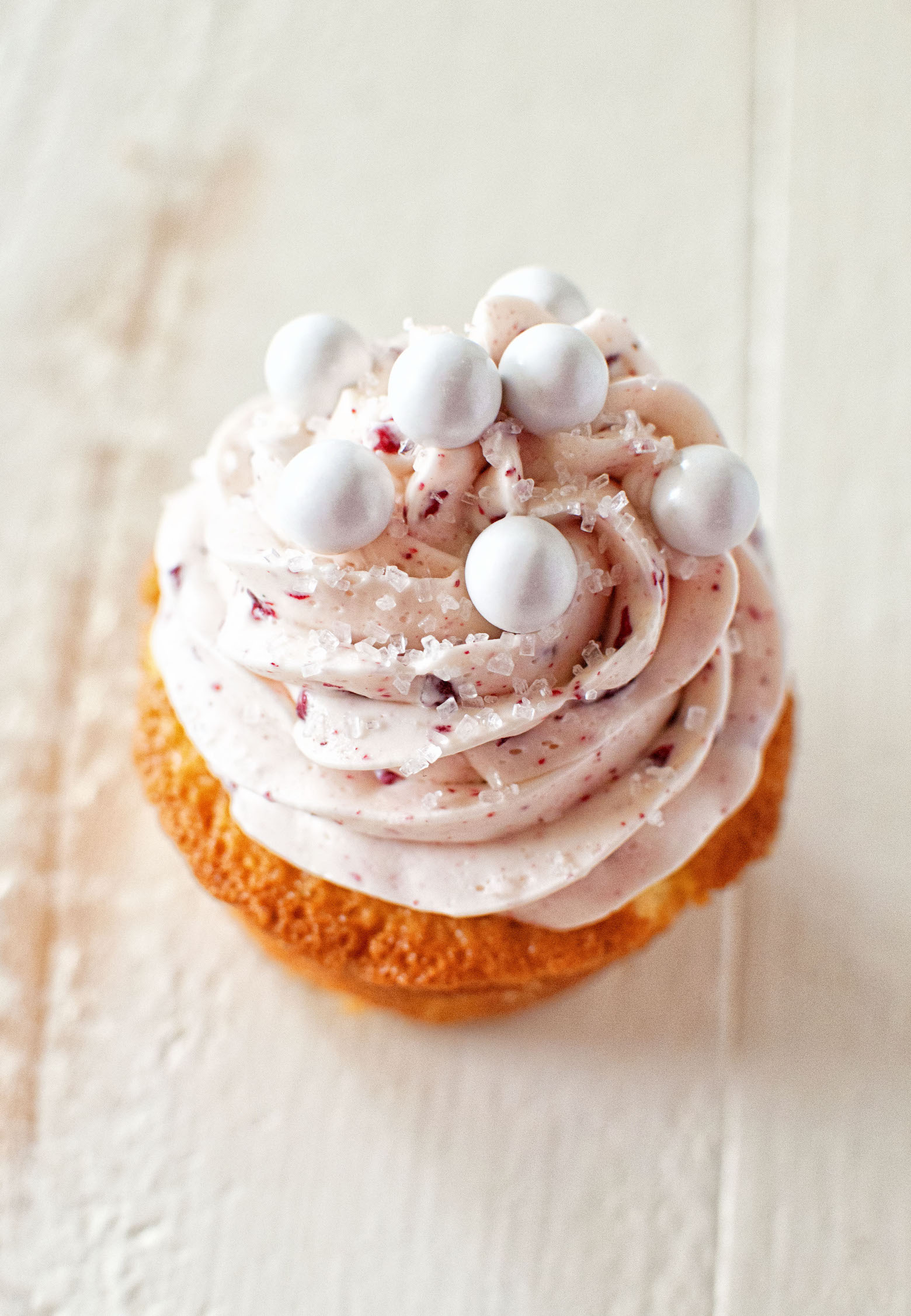 Overhead view of a single Raspberry Mimosa Cupcake. 