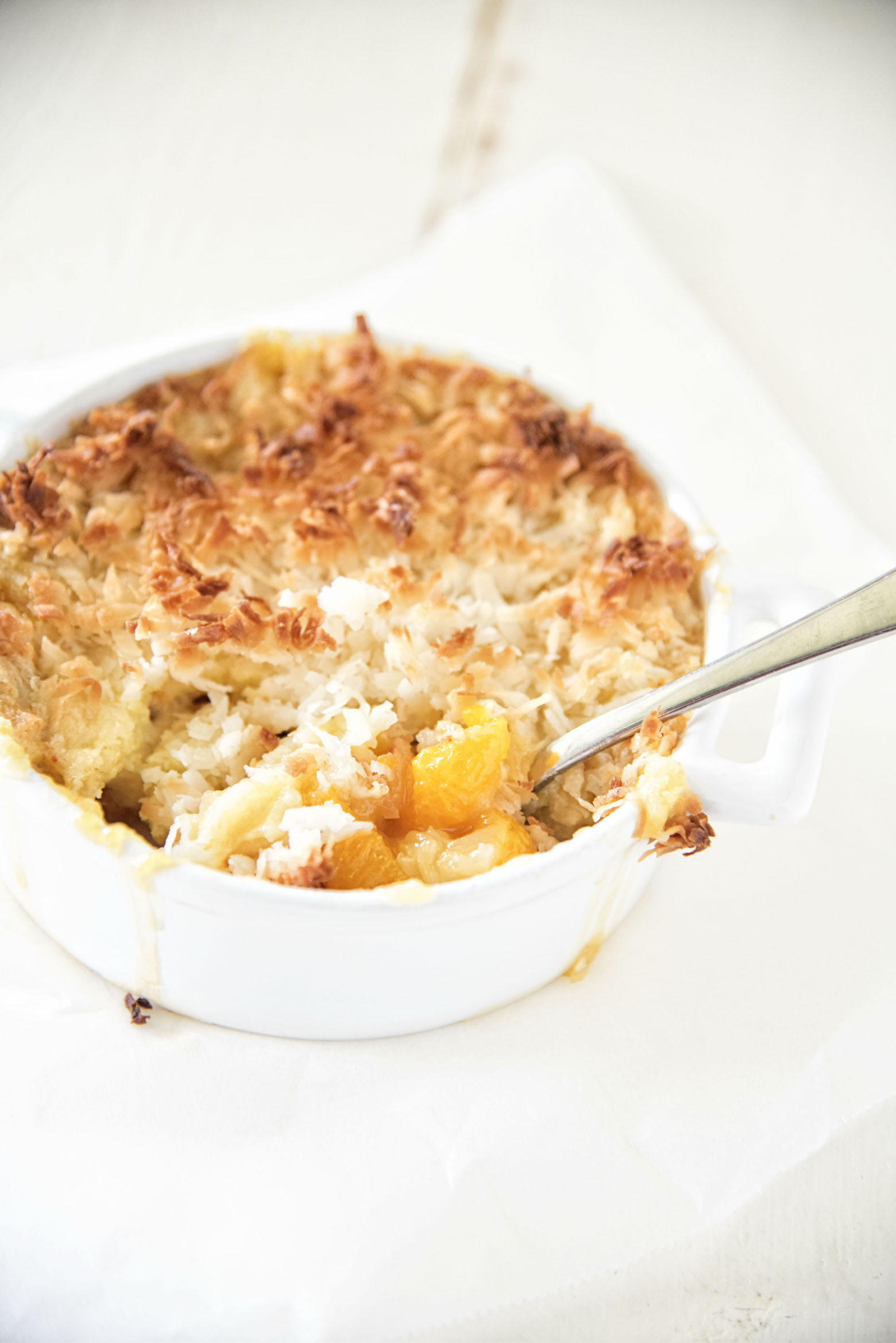 Three quarter shot of Spiced Rum Tropical Dump Cake with spoon in it.