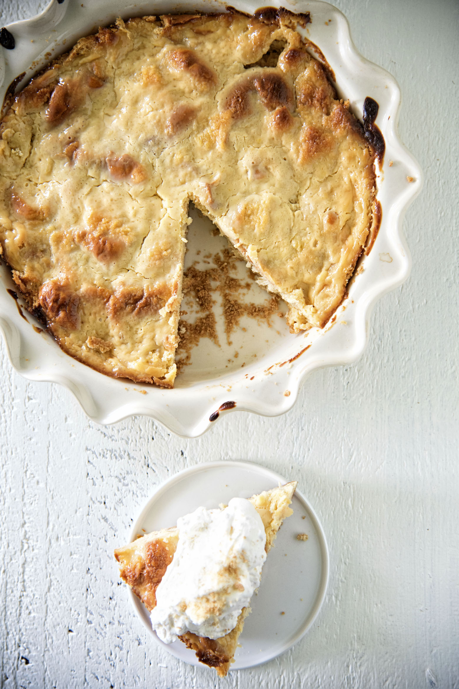 Overhead shot of Key Lime Pie Bread Pudding with piece cut out of the dish.