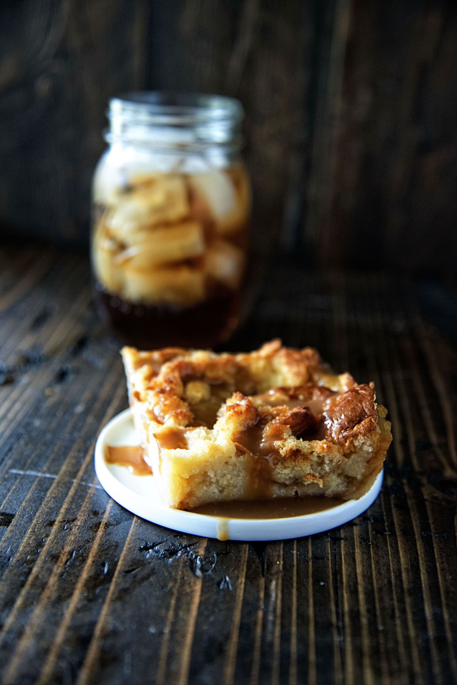 Shot of bread pudding with the sauce dripping down. 
