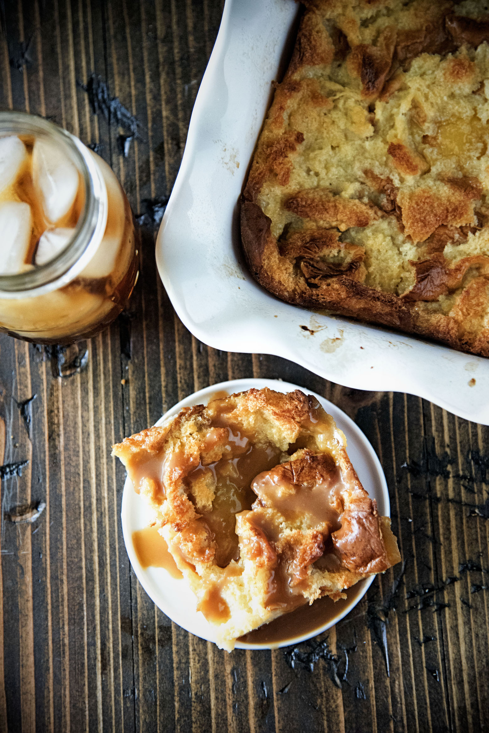 Overhead shot of bread pudding on a plate with sauce. 