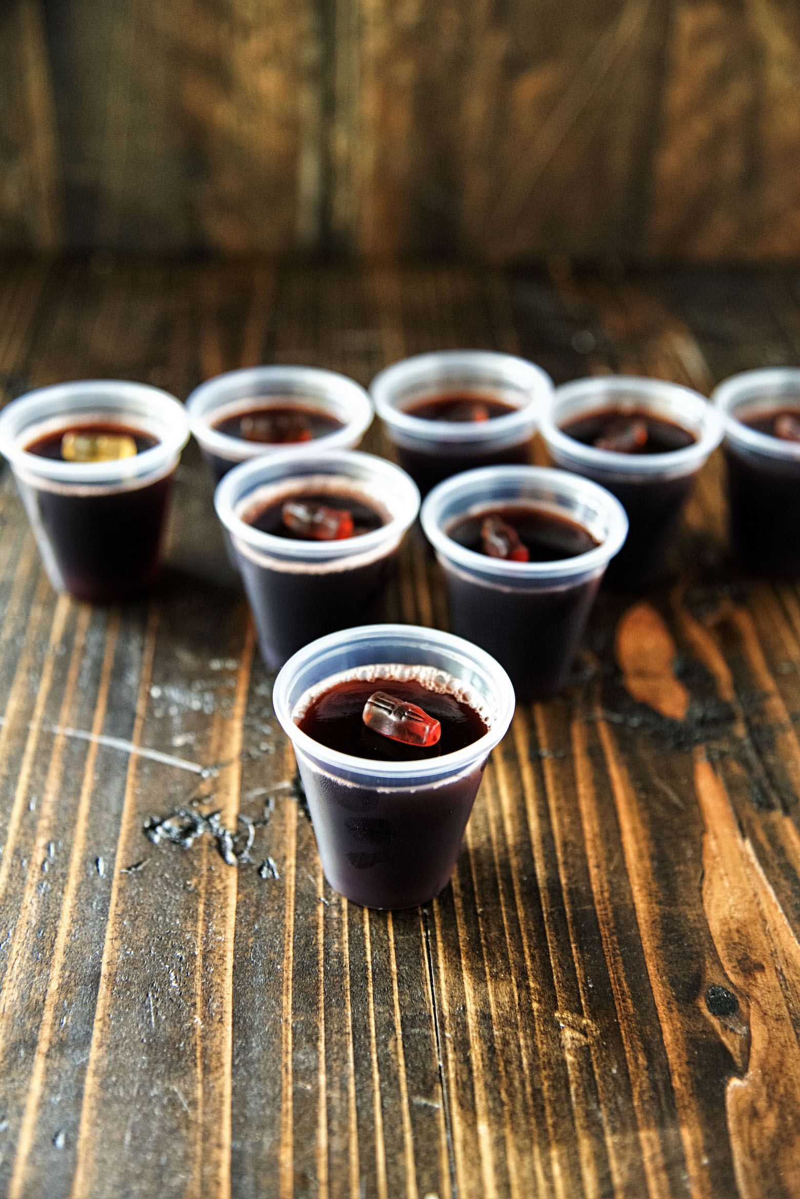 Black Cherry Spiced Rum and Coke Jell-O Shot in pyramid shape with one shot up front. 