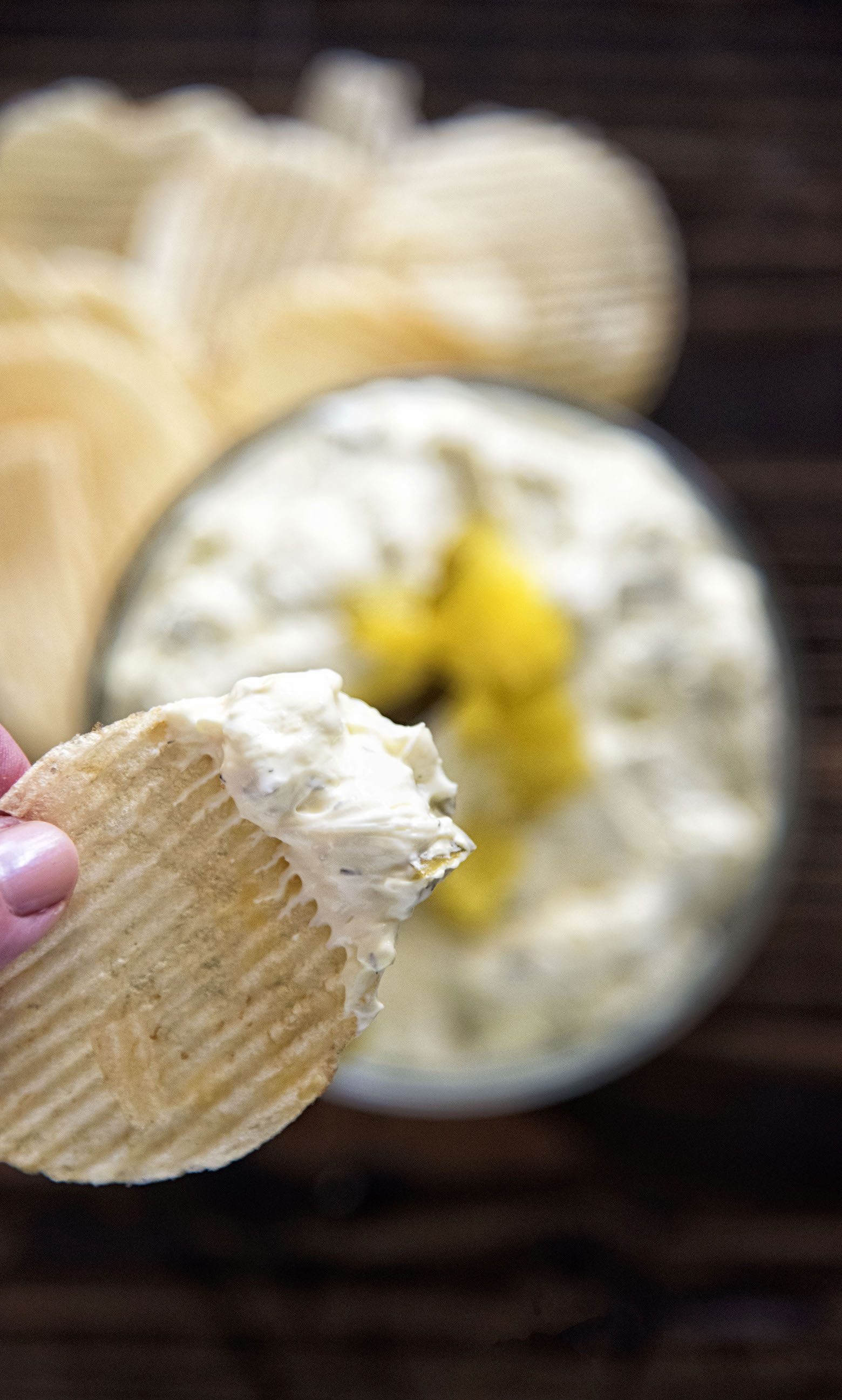 Close up of Cream Cheese Dill Pickle Dip on a chip