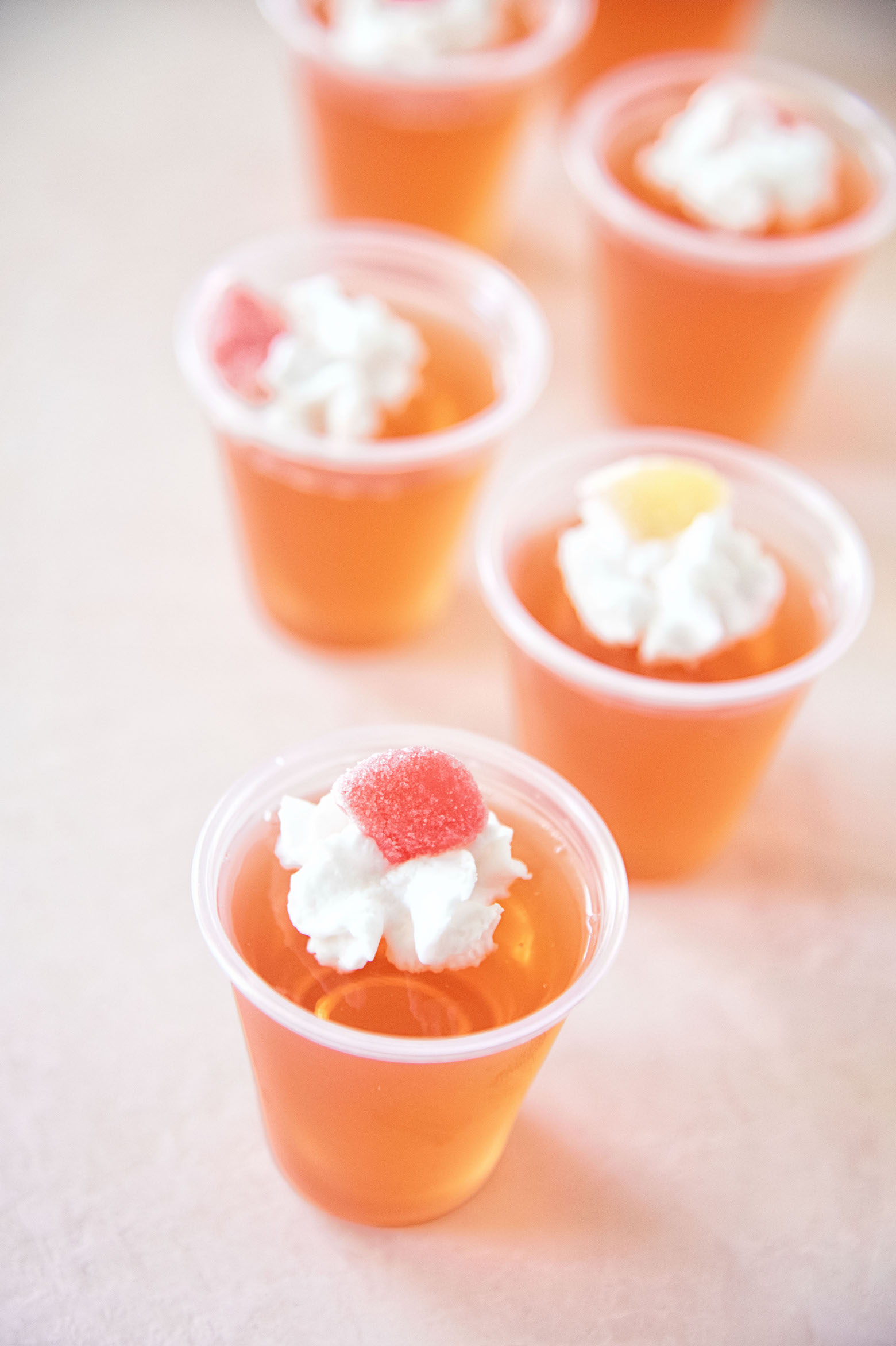 Peachy Keen Jell-O Shots in a row. Part of the Best Jello Shot Recipes round up.