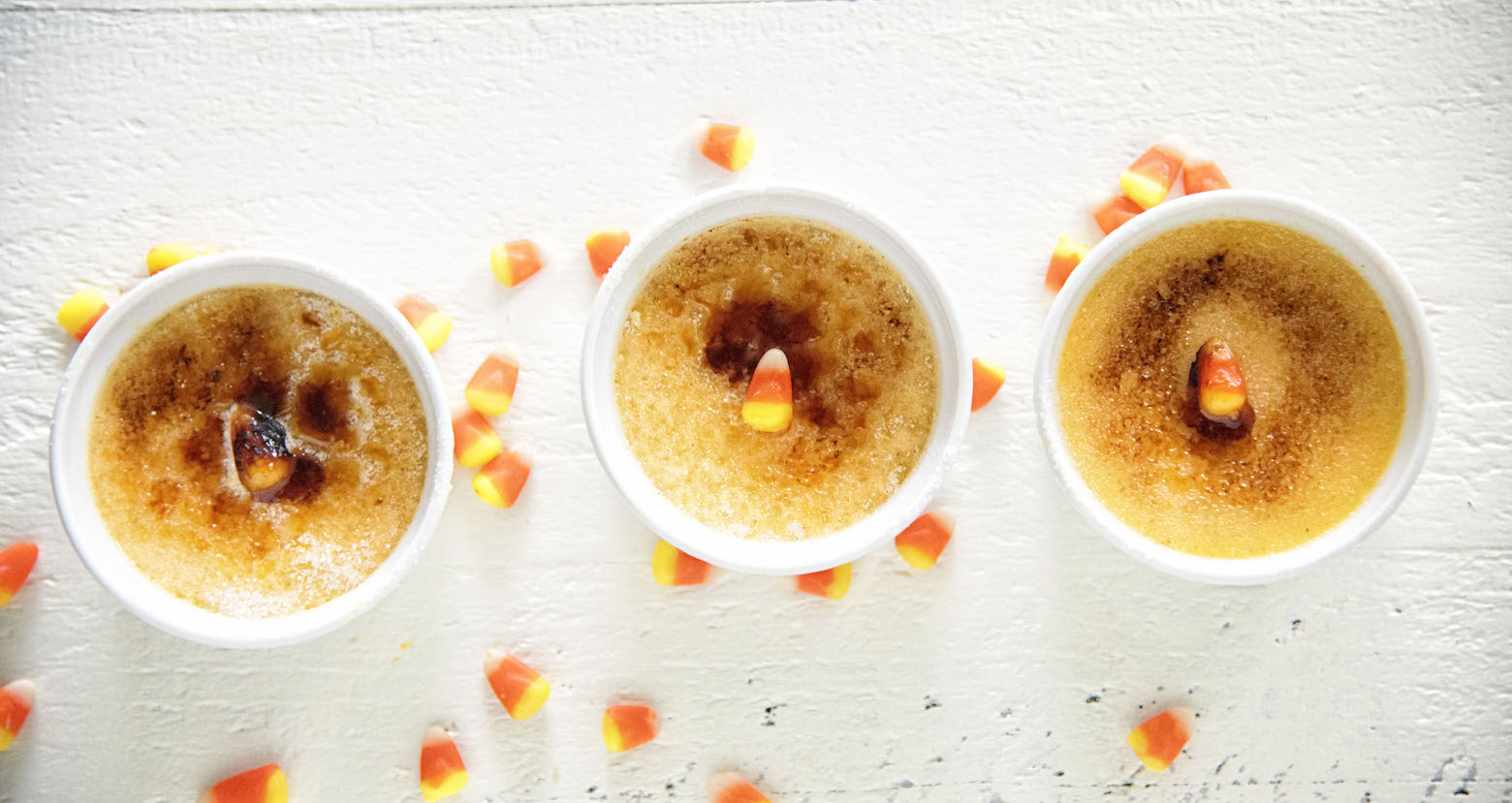 Three Candy Corn Creme Brûlées all in a row