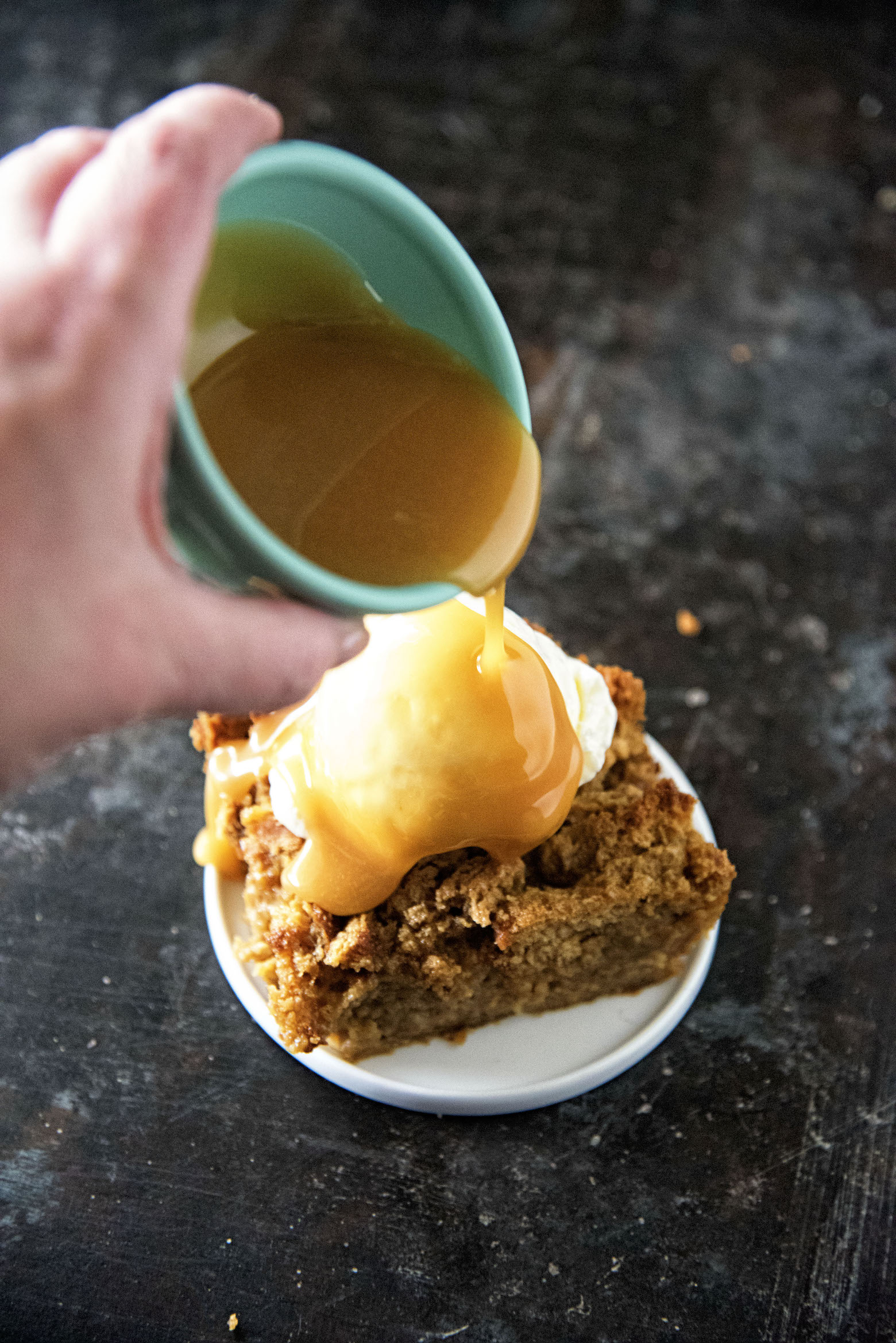 Pouring the orange caramel sauce over the Gingerbread Bread Pudding