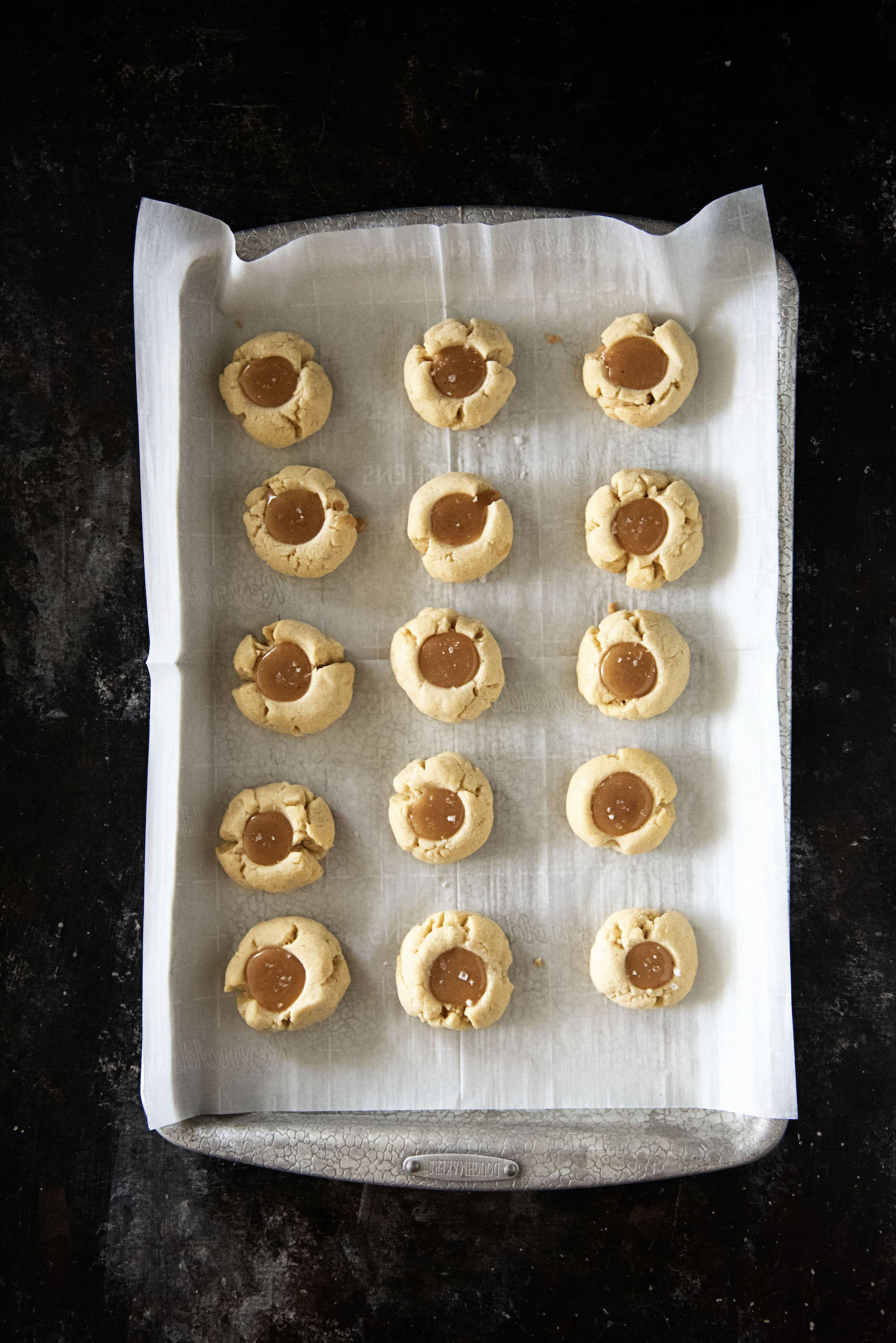 Vanilla Bean Caramel Thumbprint Cookies overhead shot on tray.