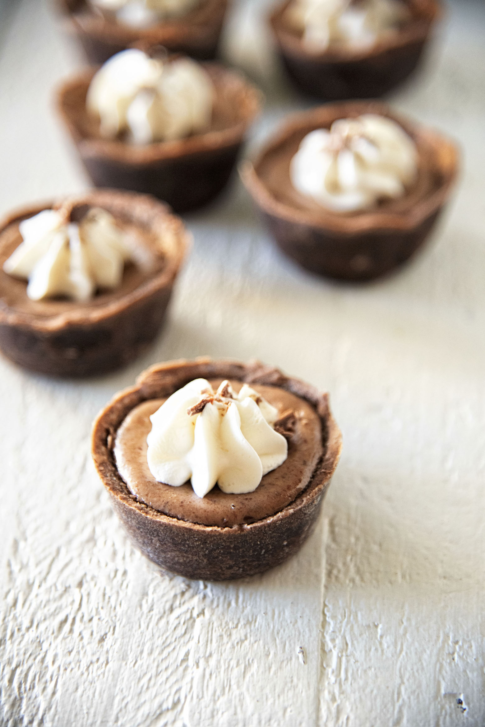 Mini Bailey's Irish Cream Mocha Cheesecake Tarts with one up front 