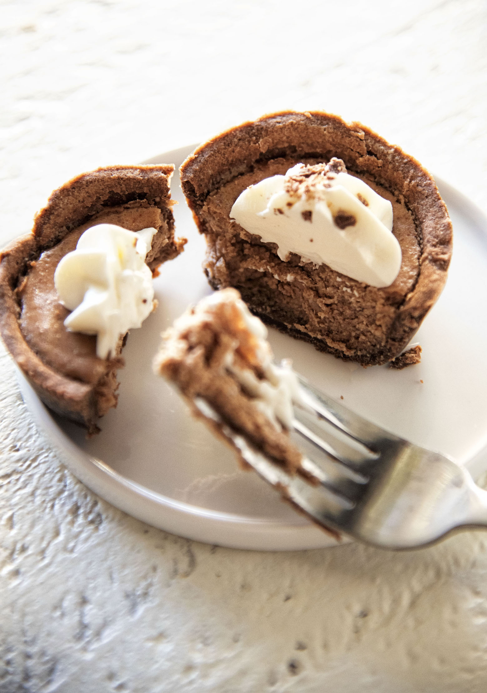 Mini Bailey's Irish Cream Mocha Cheesecake Tarts cut in half with a fork. 