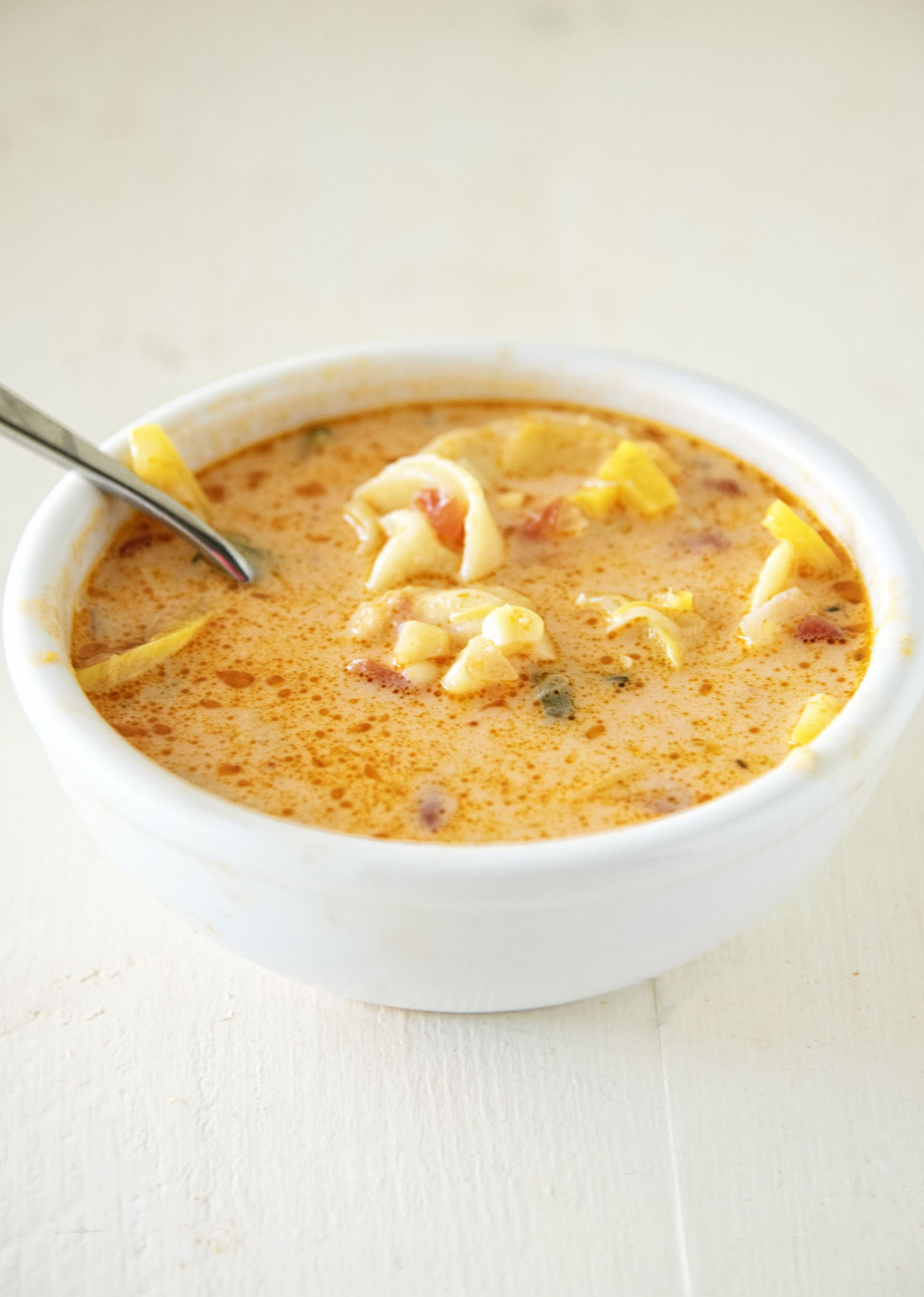 Side view of Cheese Tortellini Zucchini Corn Soup in bowl