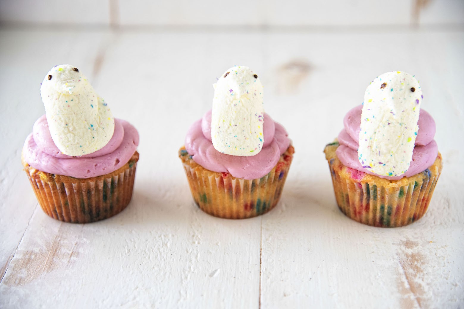A display of 3 Confetti Vanilla Marshmallow Peep Cupcakes.