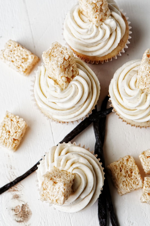 Overhead shot of Vanilla Bean Rice Krispie Treat Cupcakes with vanilla bean pod. 