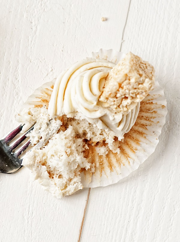 Overhead shot of Vanilla Bean Rice Krispie Treat Cupcakes with fork cutting into it. 