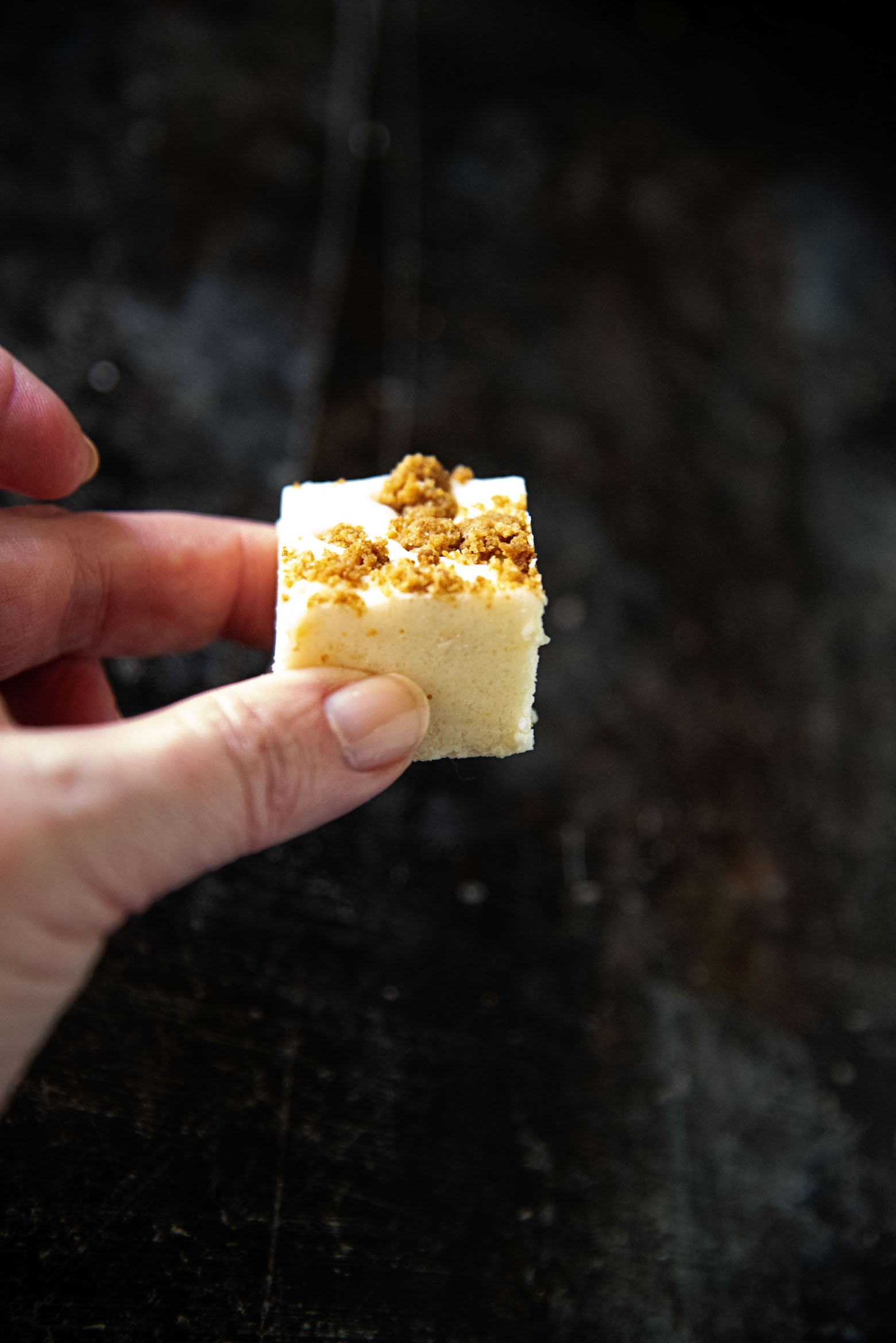 Peach Pie Fudge being held in hand. 