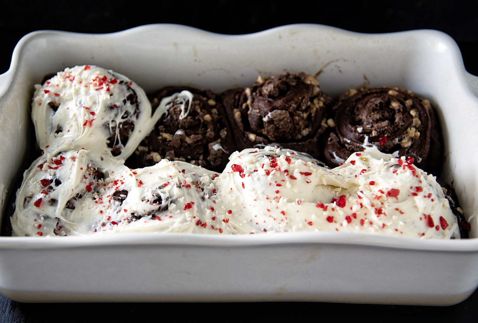 Pan of half frosted Peppermint Mocha Latte Sweet Rolls