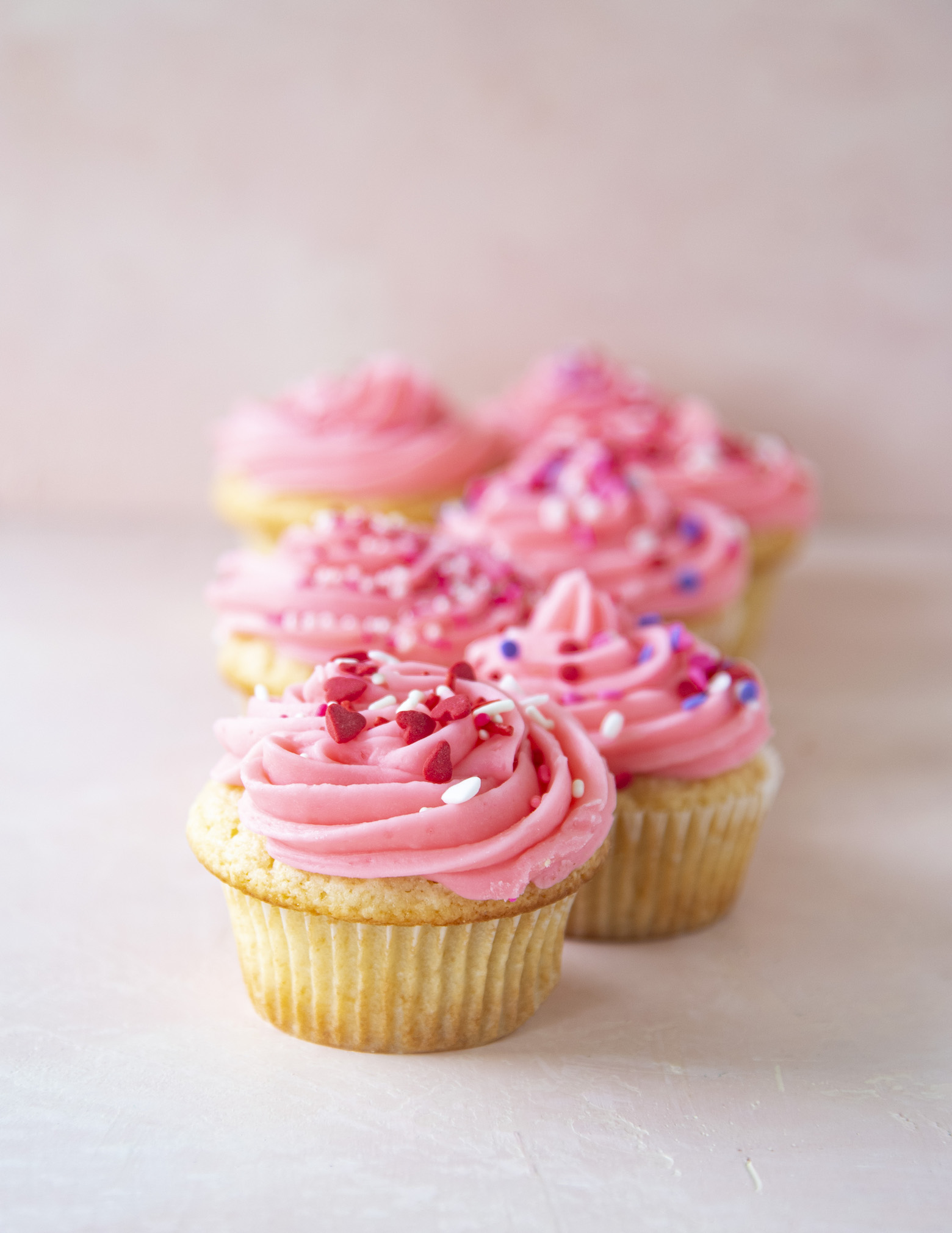 A row of Pink Vanilla-Vanilla Cupcakes 