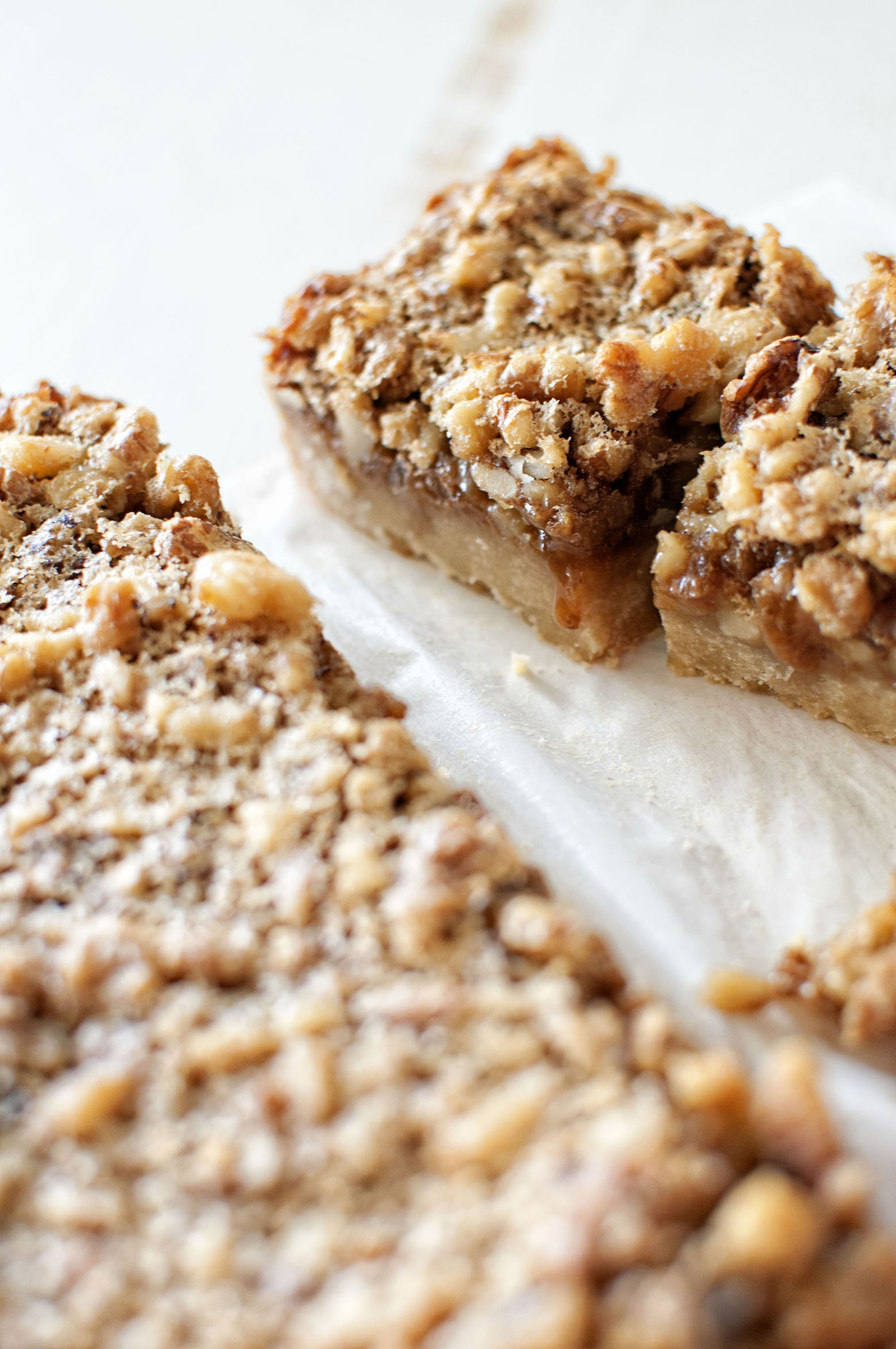 Close up of a Maple Walnut Bourbon Bar in the background with the uncut bars being upfront. 