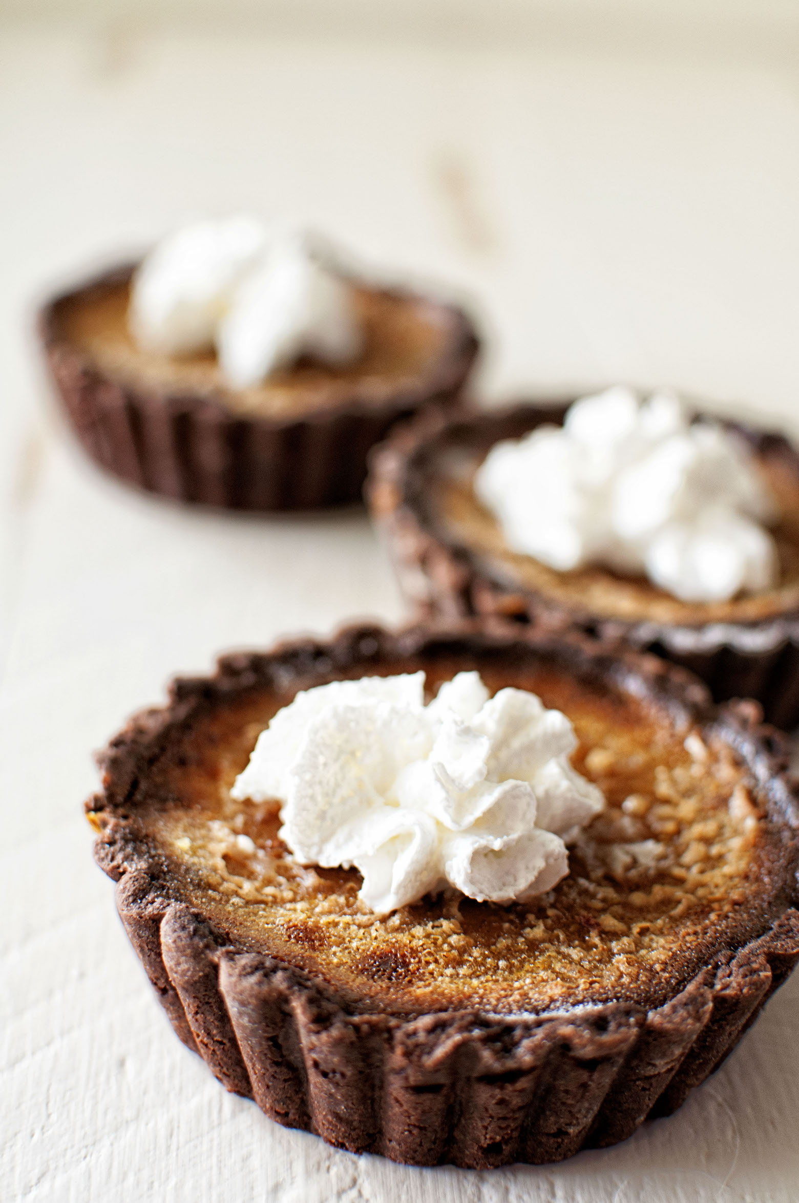 Pumpkin Creme Brûlée Tartlets with Chocolate Ginger Crust