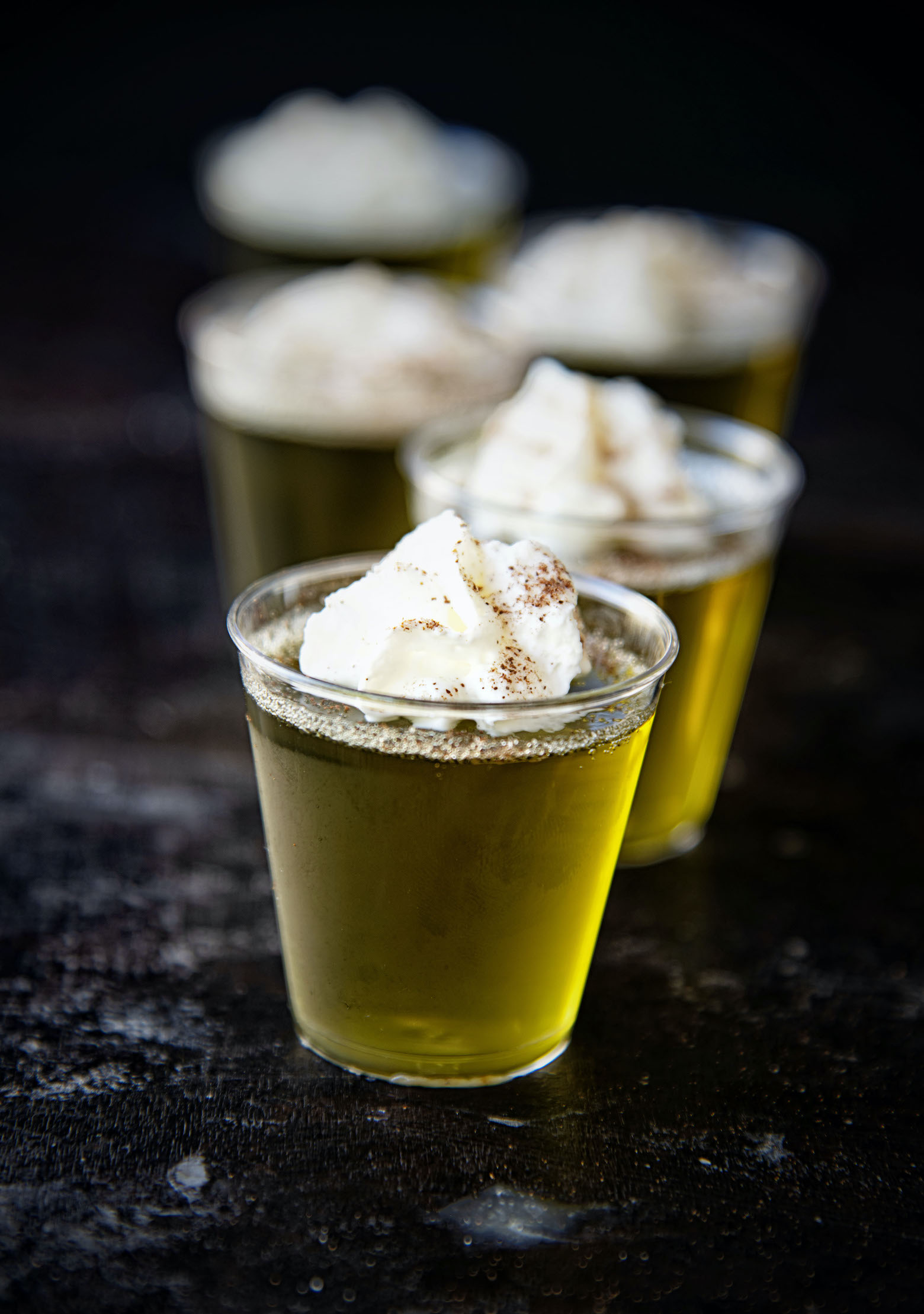 Apple Pie Moonshine Jello Shots in a row with the focus on the first shot.