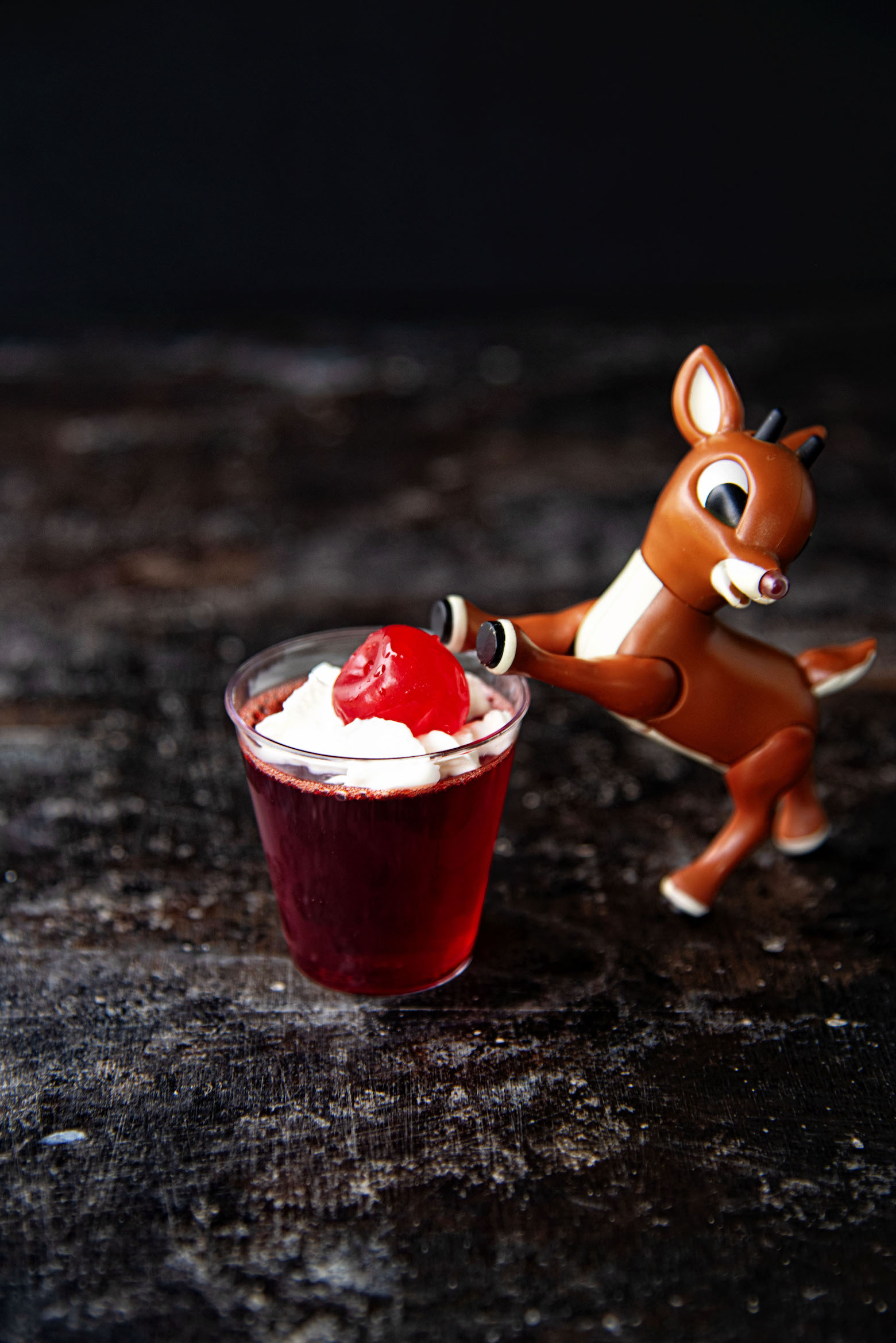 Rudolph having his front hooves up on the jello shot.