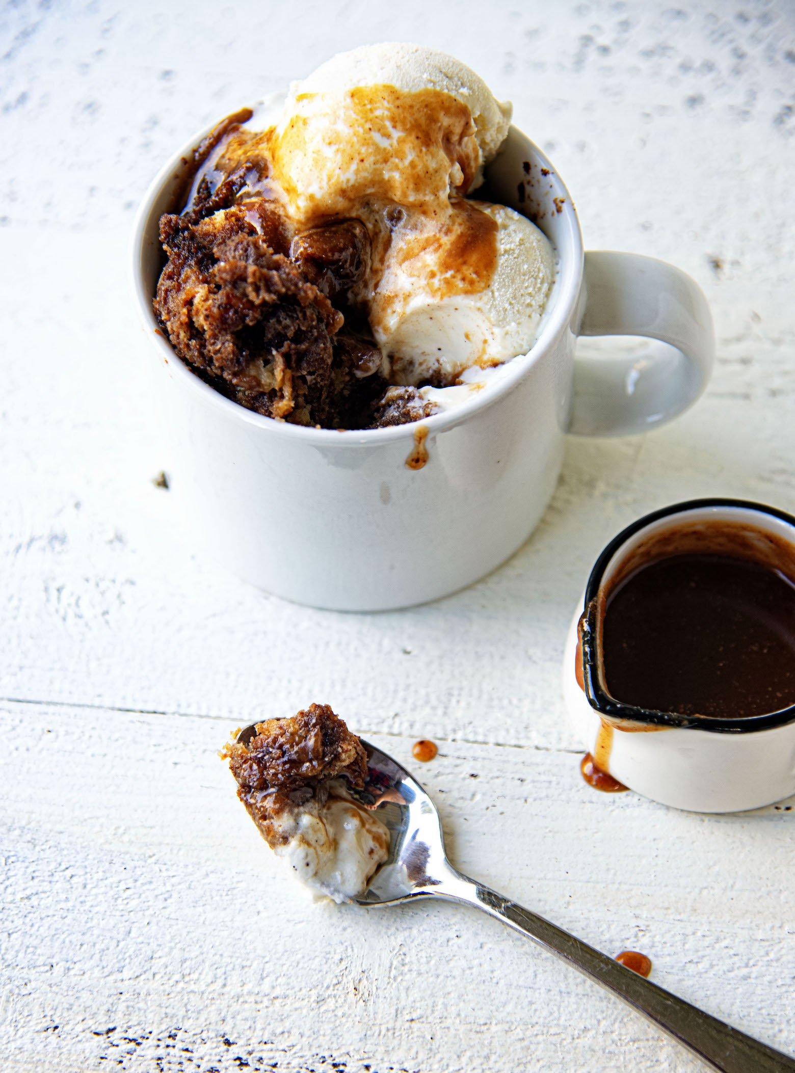 Coffee and Donuts Bread Pudding on a spoon with ice cream.