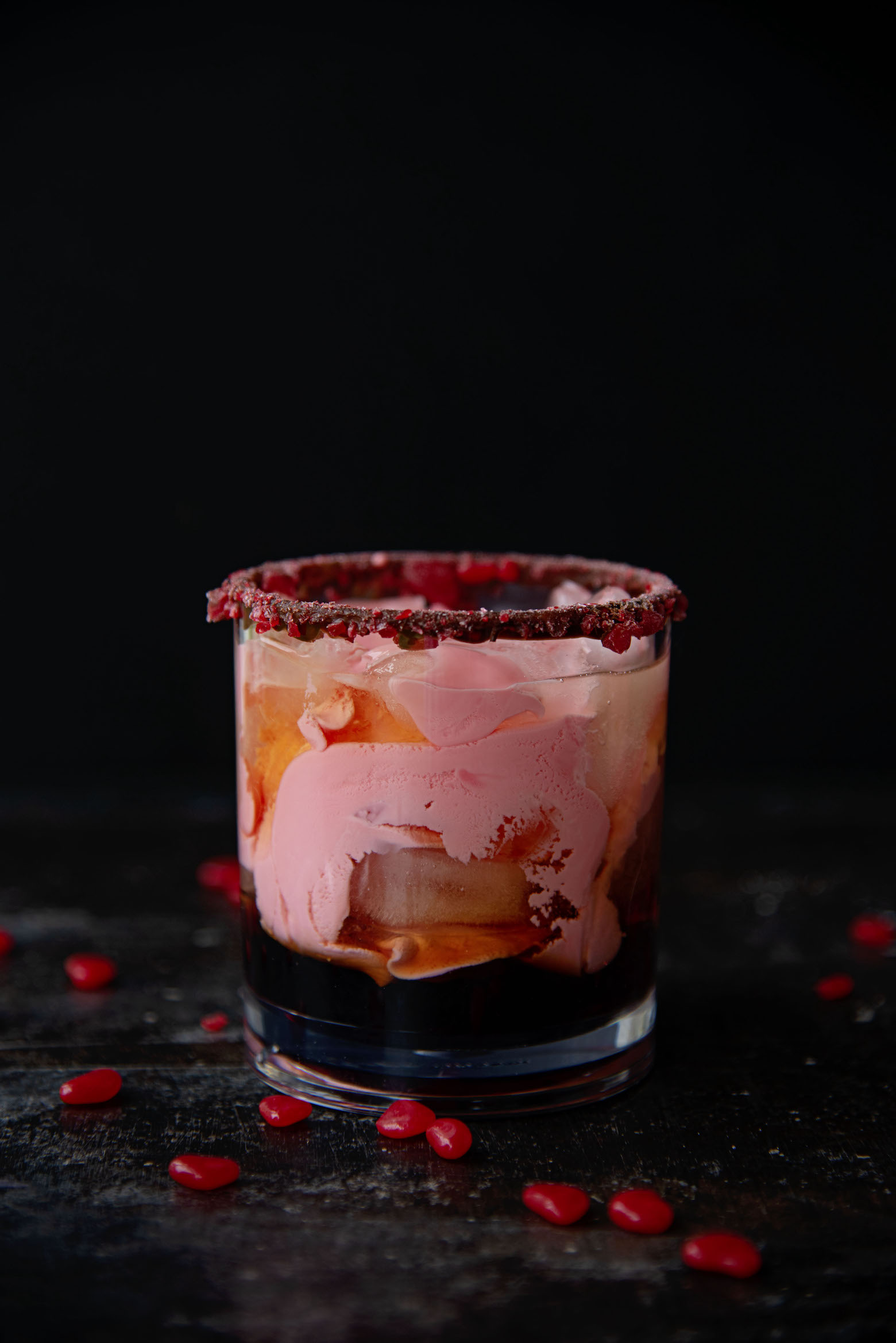 Side view of a single glass of a Cinnamon Red Hots White Russian 