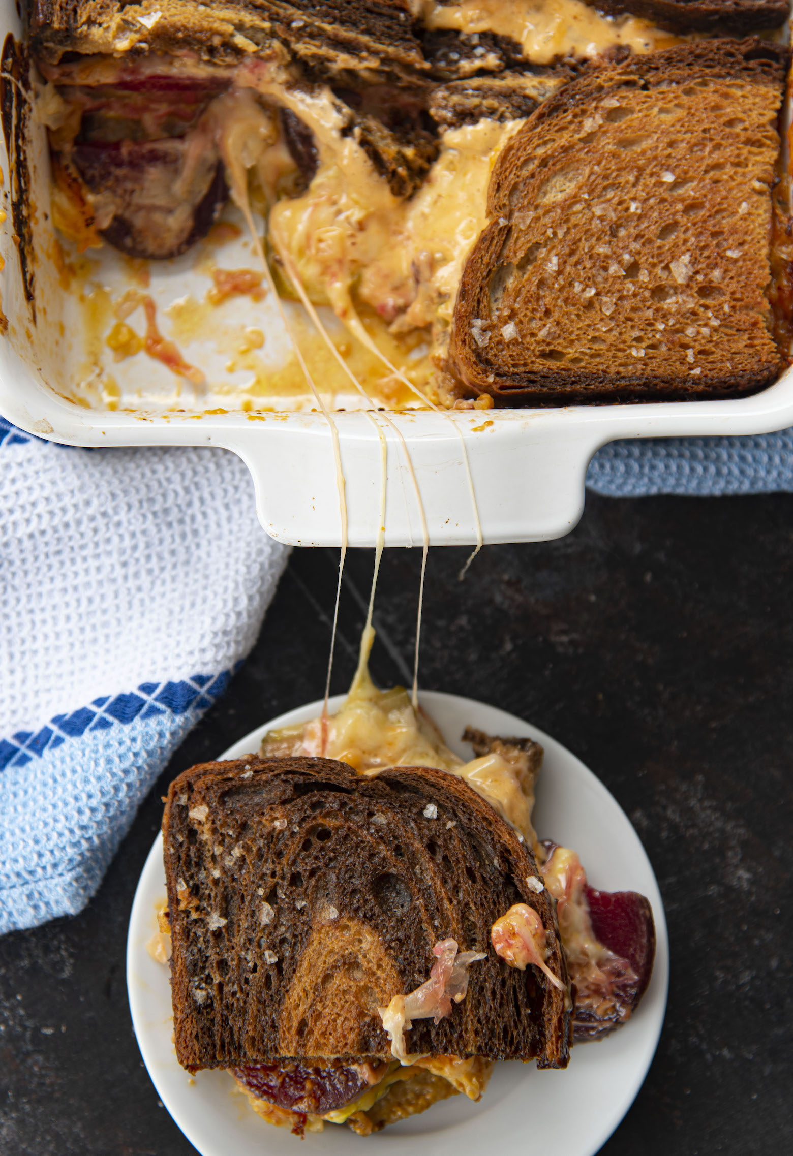 Overhead shot of Easy Vegetarian Reuben Casserole with a slice out of the casserole with melted cheese. 