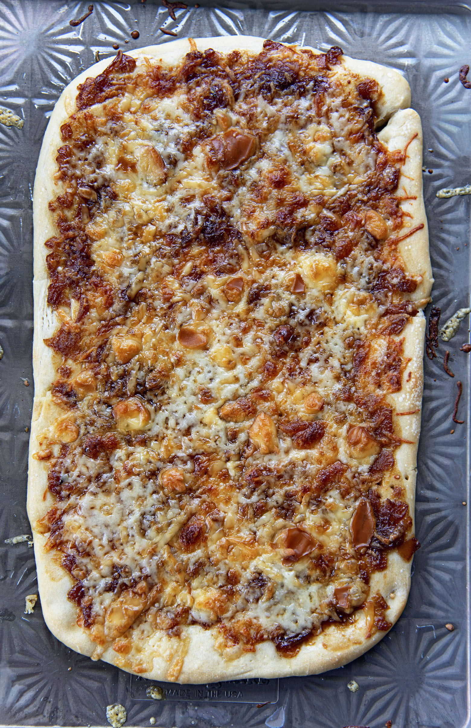 Full sheet of French Onion Soup Flatbread on baking sheet. 