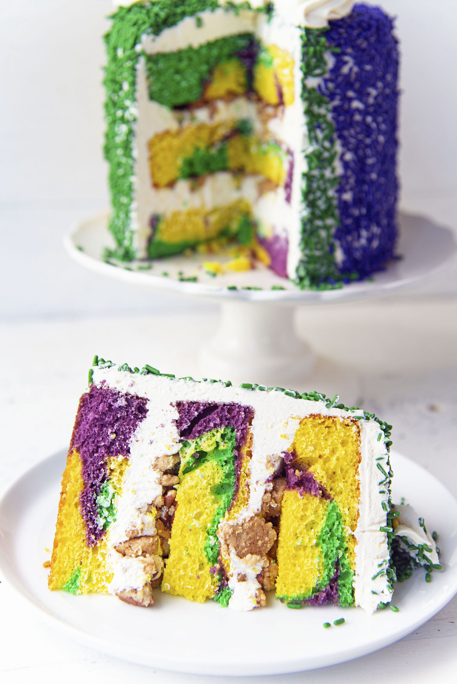 King Cake Layer Cake with slice up front and cake in back.