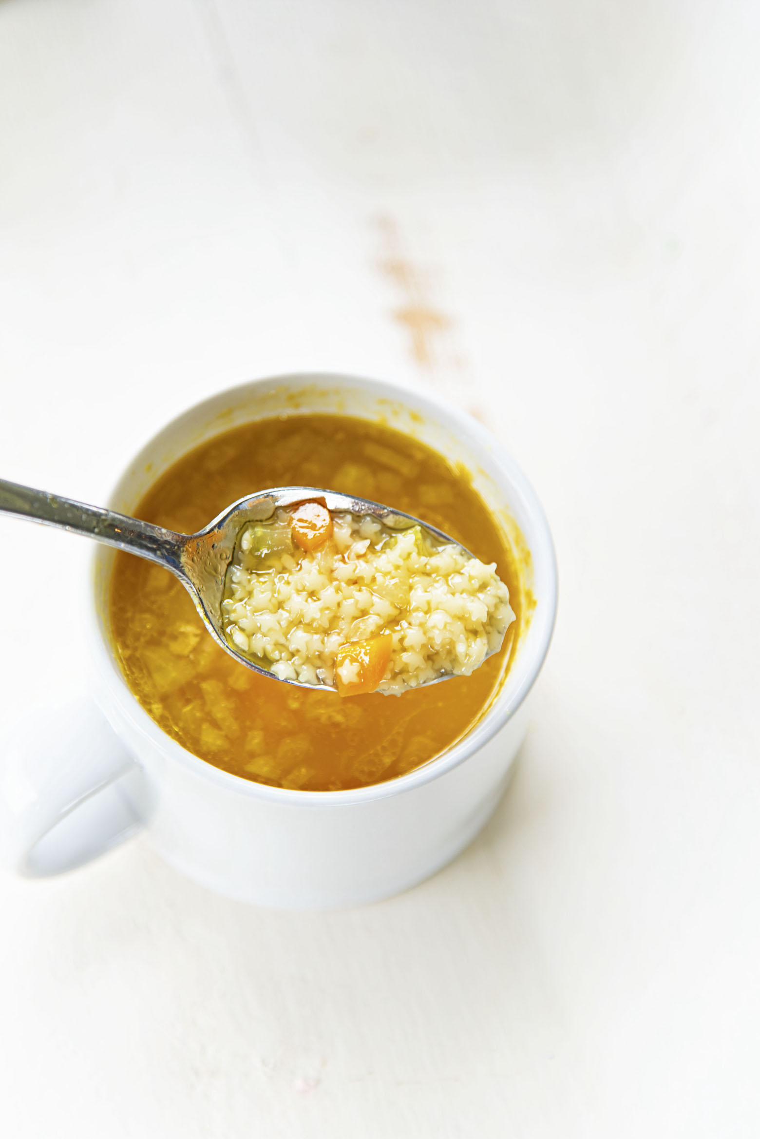 Shot of Chickenless Chicken and Stars Soup with spoon filled with soup.