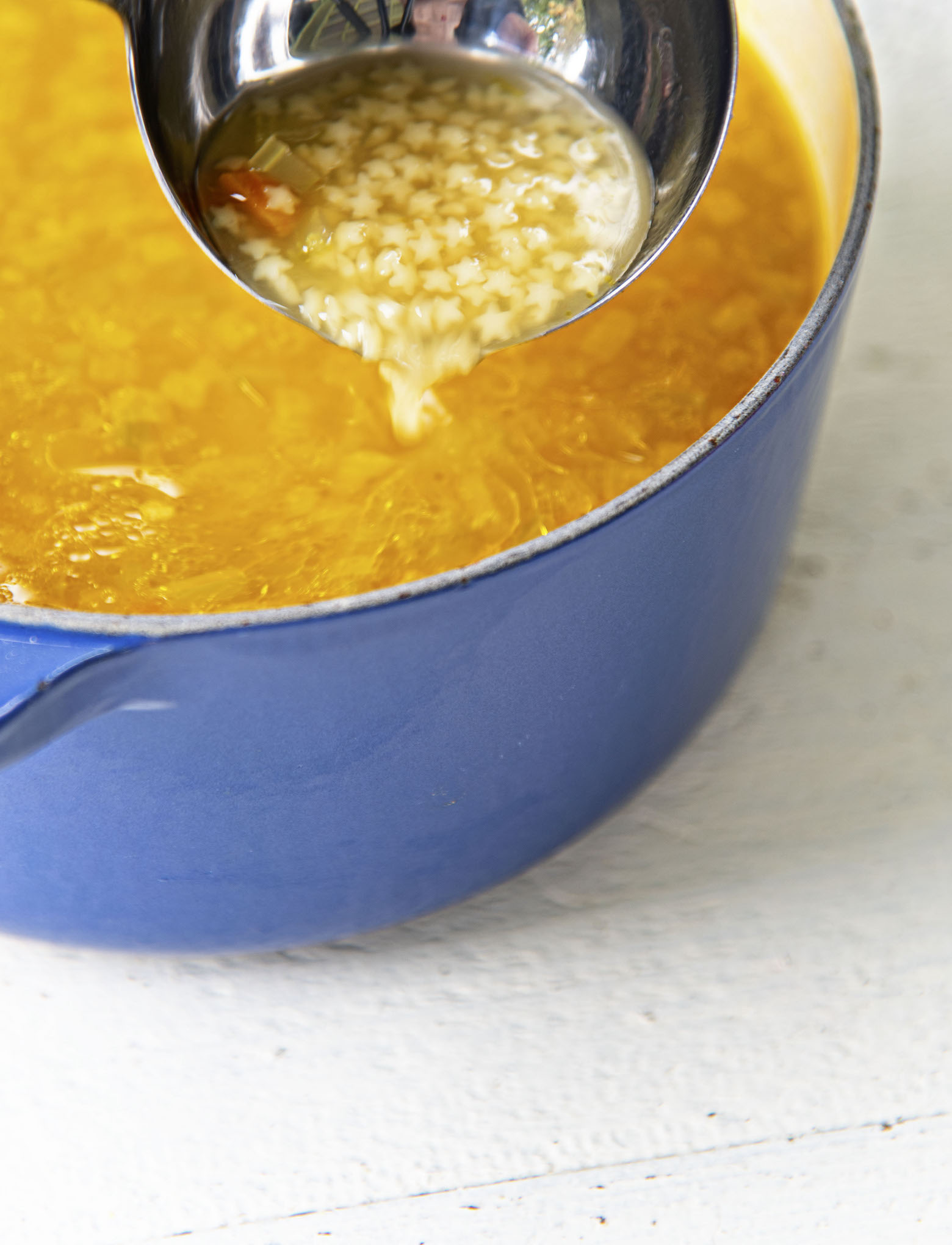 Soup ladle pouring out Chickenless Chicken and Stars Soup