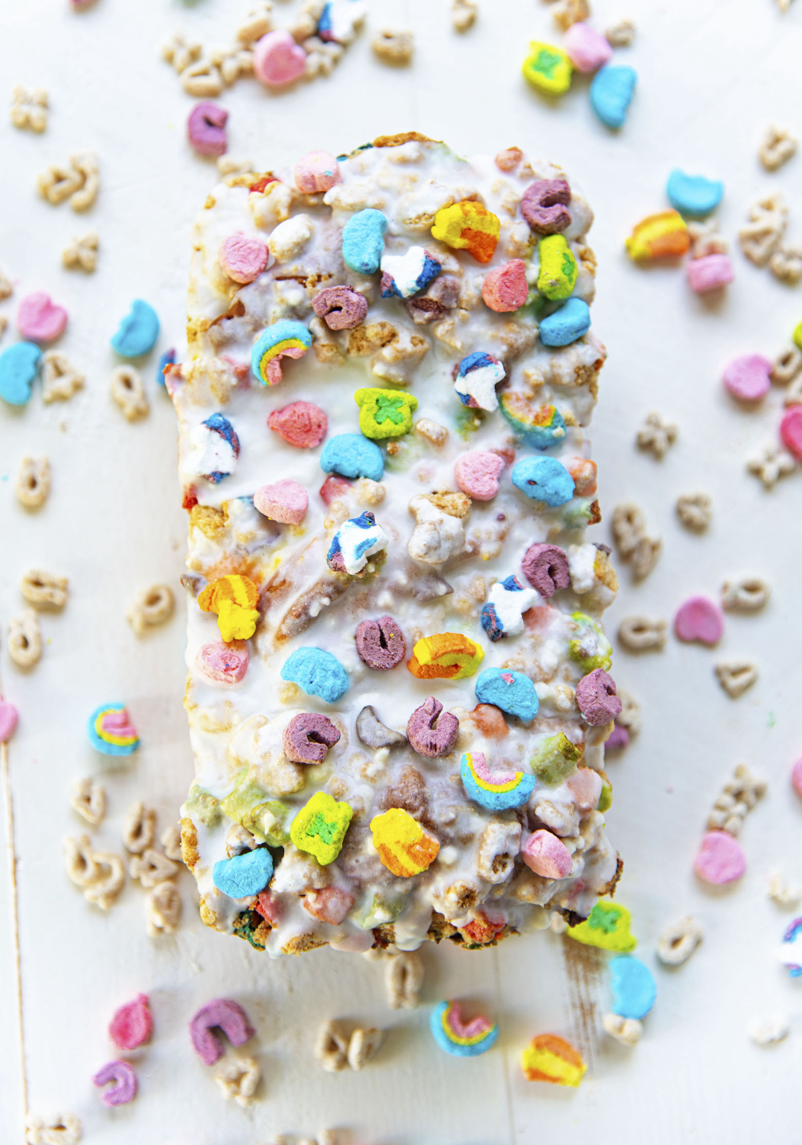 Overhead shot of whole loaf of yeasted cake covered in glaze and marshmallows. 