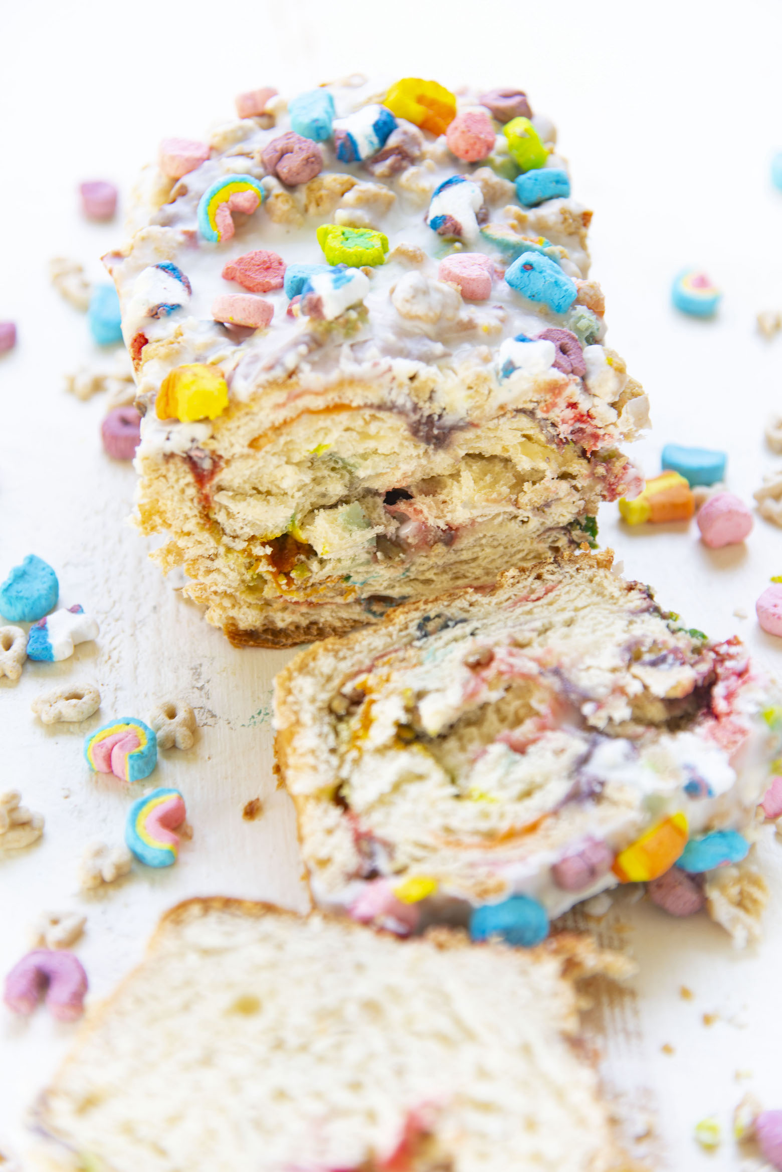 Three quarter view photo of sliced loaf surrounded by marshmallows. 