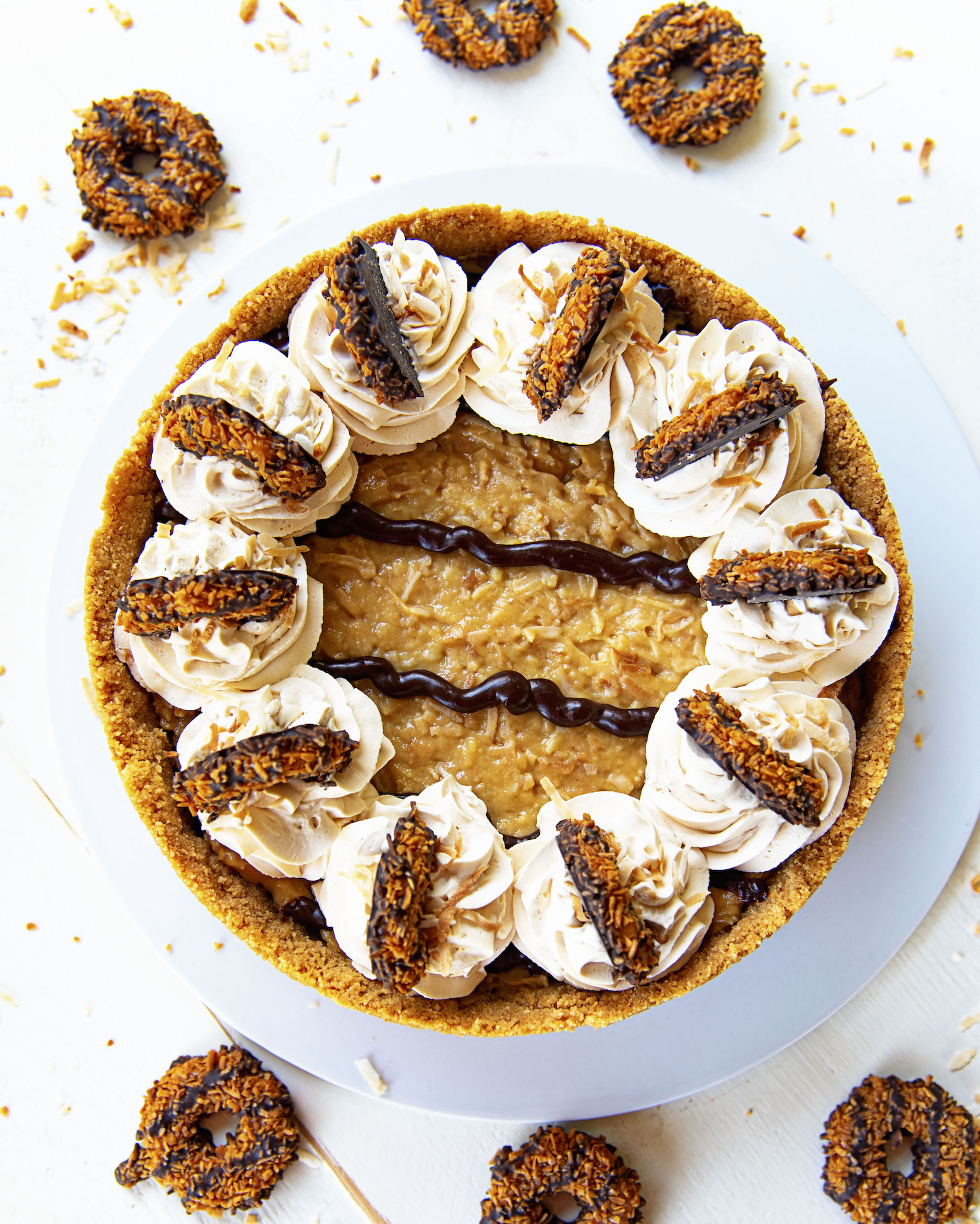 Overhead shot of Samoas Chocolate Coconut Cream Pie with scattered Samoas cookies.