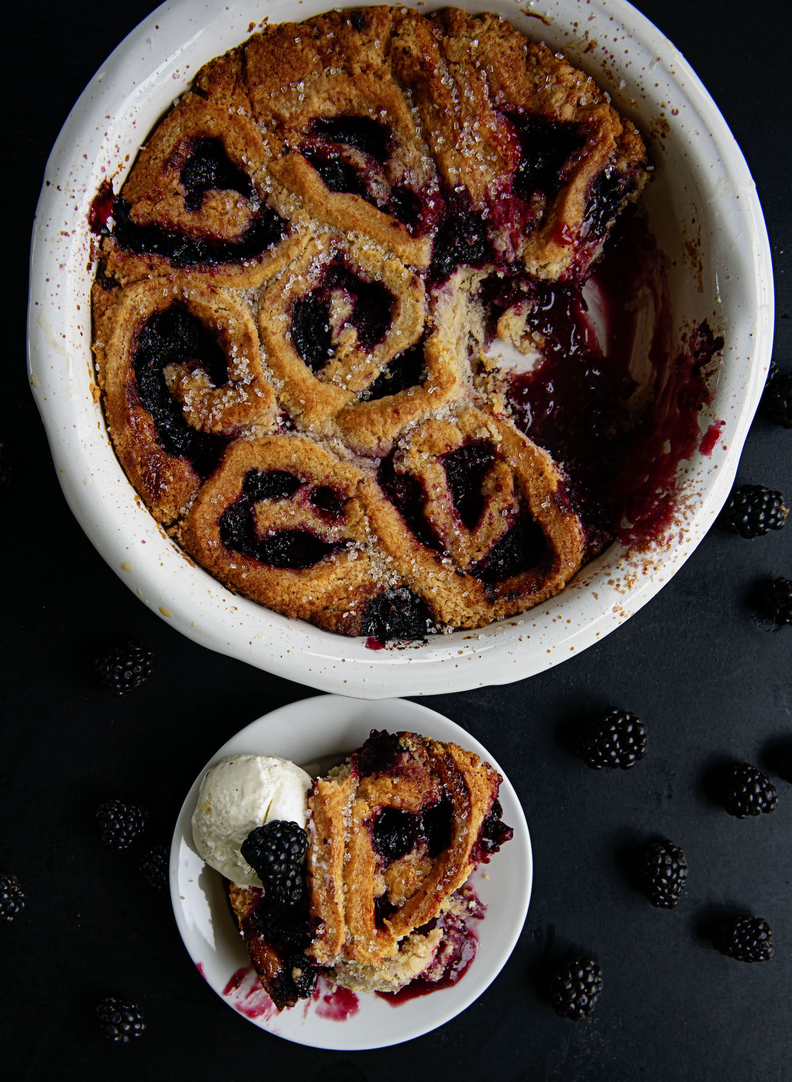 Overhead view of Blackberry Lime Curd Biscuit Cobbler with a scoop taking out. 