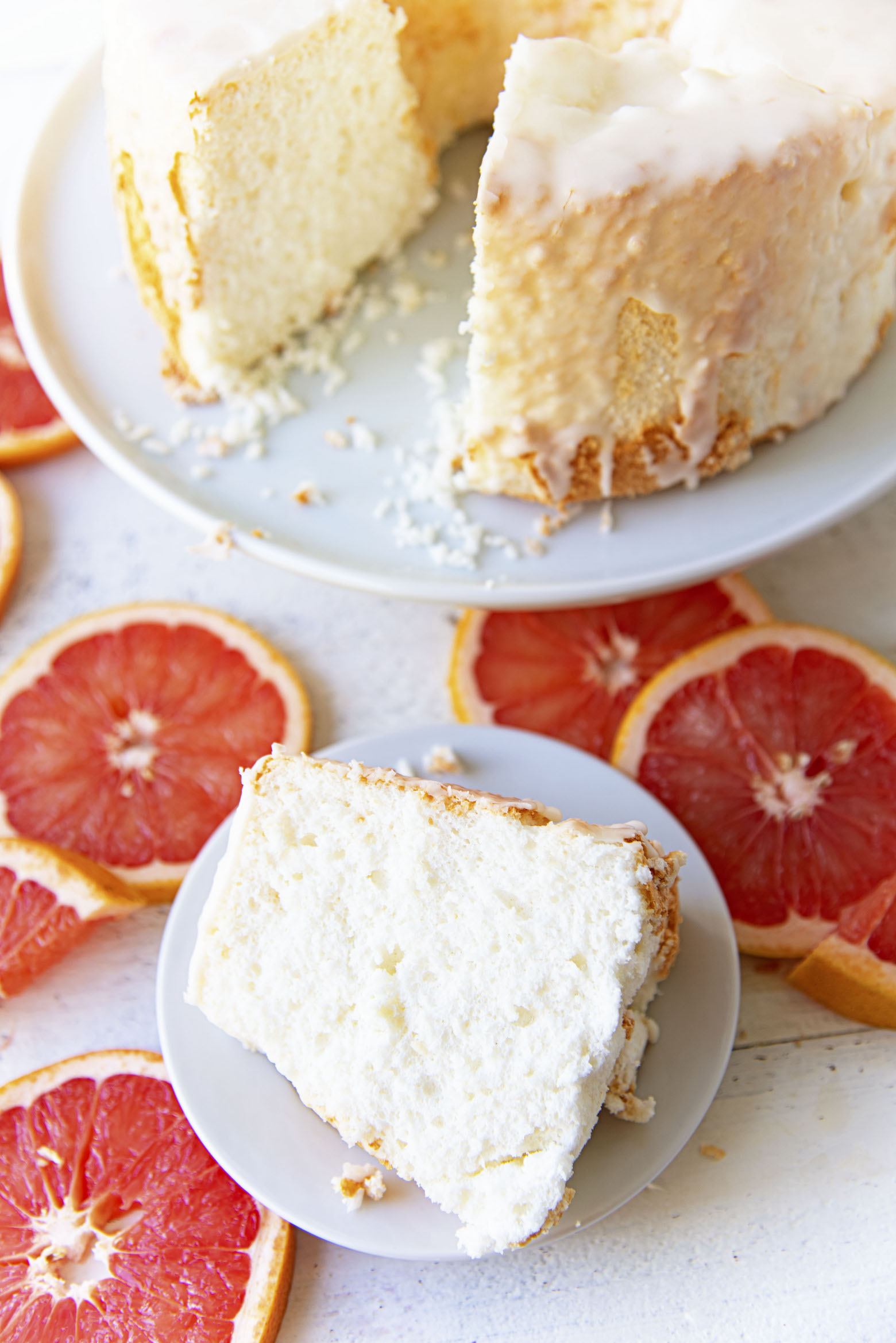 Overhead view of Ruby Red Grapefruit Glazed Angel Food Cake with slice cut out. 