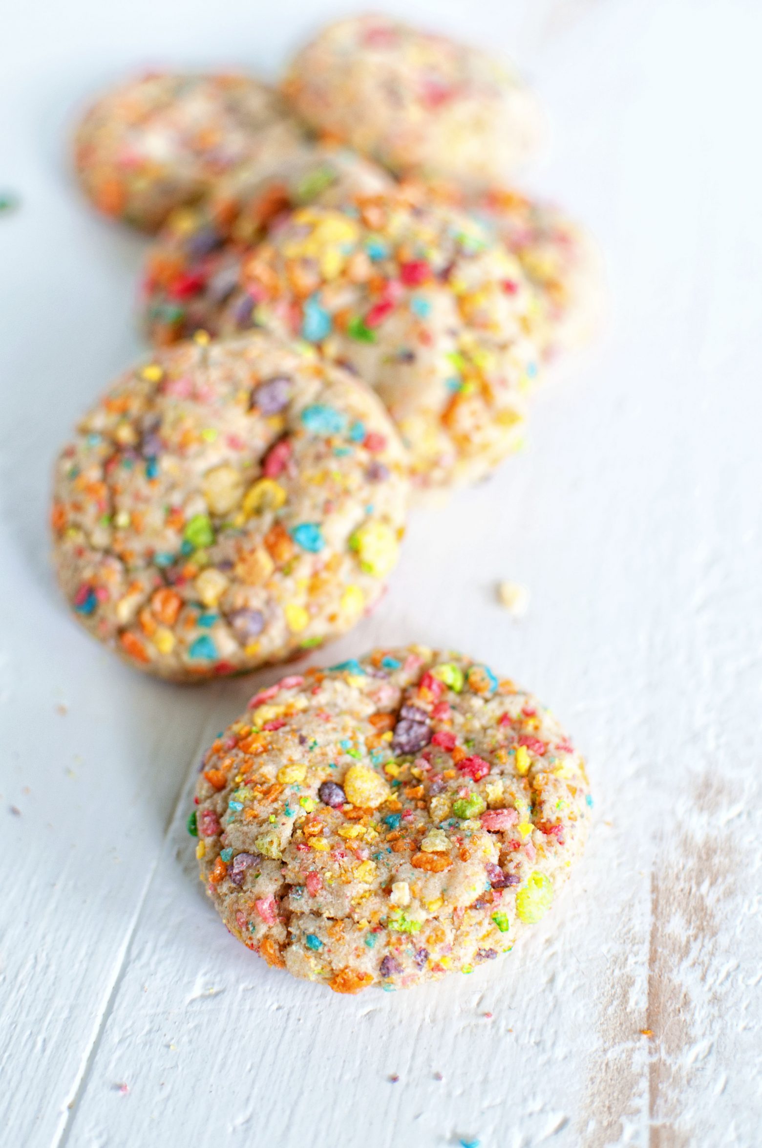White Chocolate Chip Fruity Pebbles Cookies lined up in a row