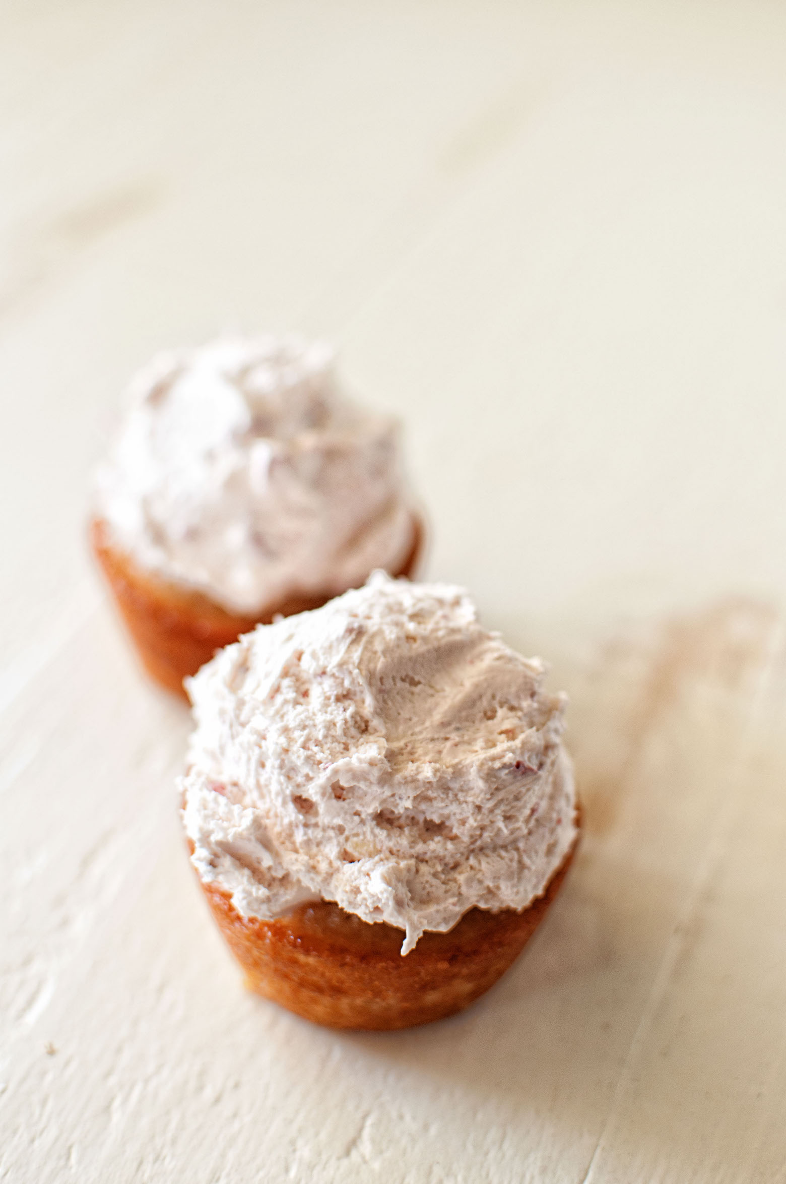 Two strawberry and cream cupcakes