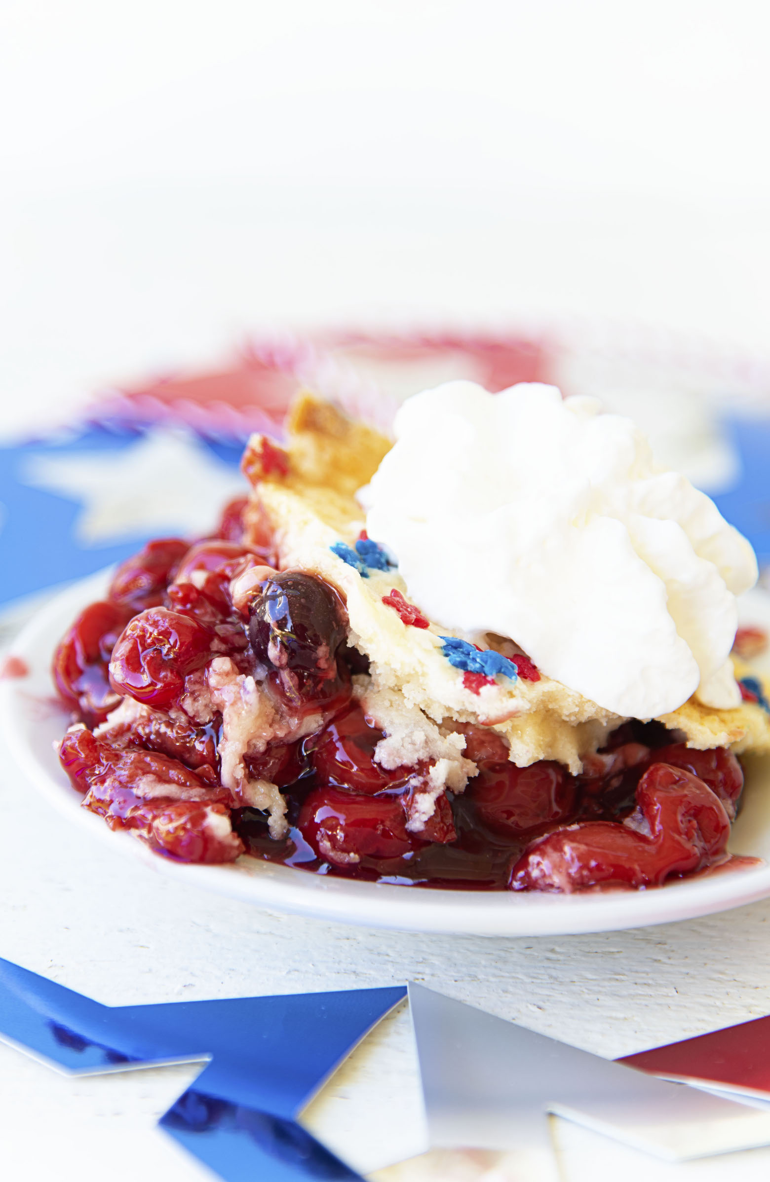 Side view of Cherry Blueberry Dump Cake on a plate. 