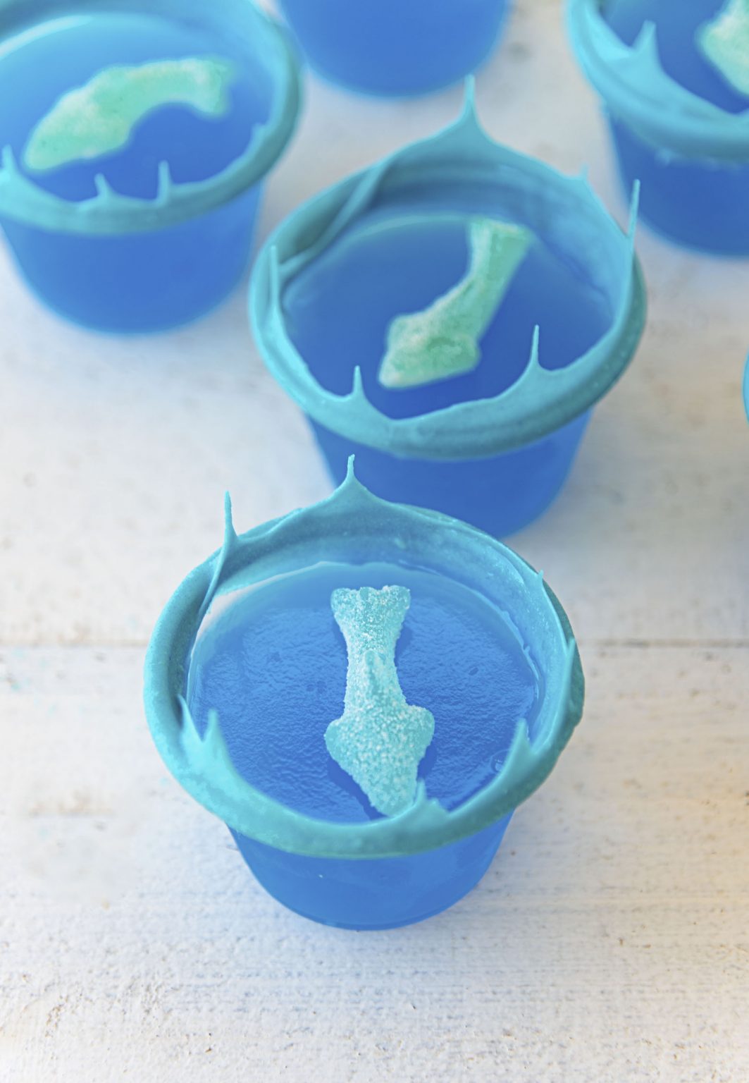 Ocean Water Jello Shots With White Chocolate Waves And Gummy Sharks