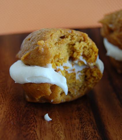 Pumpkin Whoopie Pies with Maple Cream Cheese Filling with bite out of it.